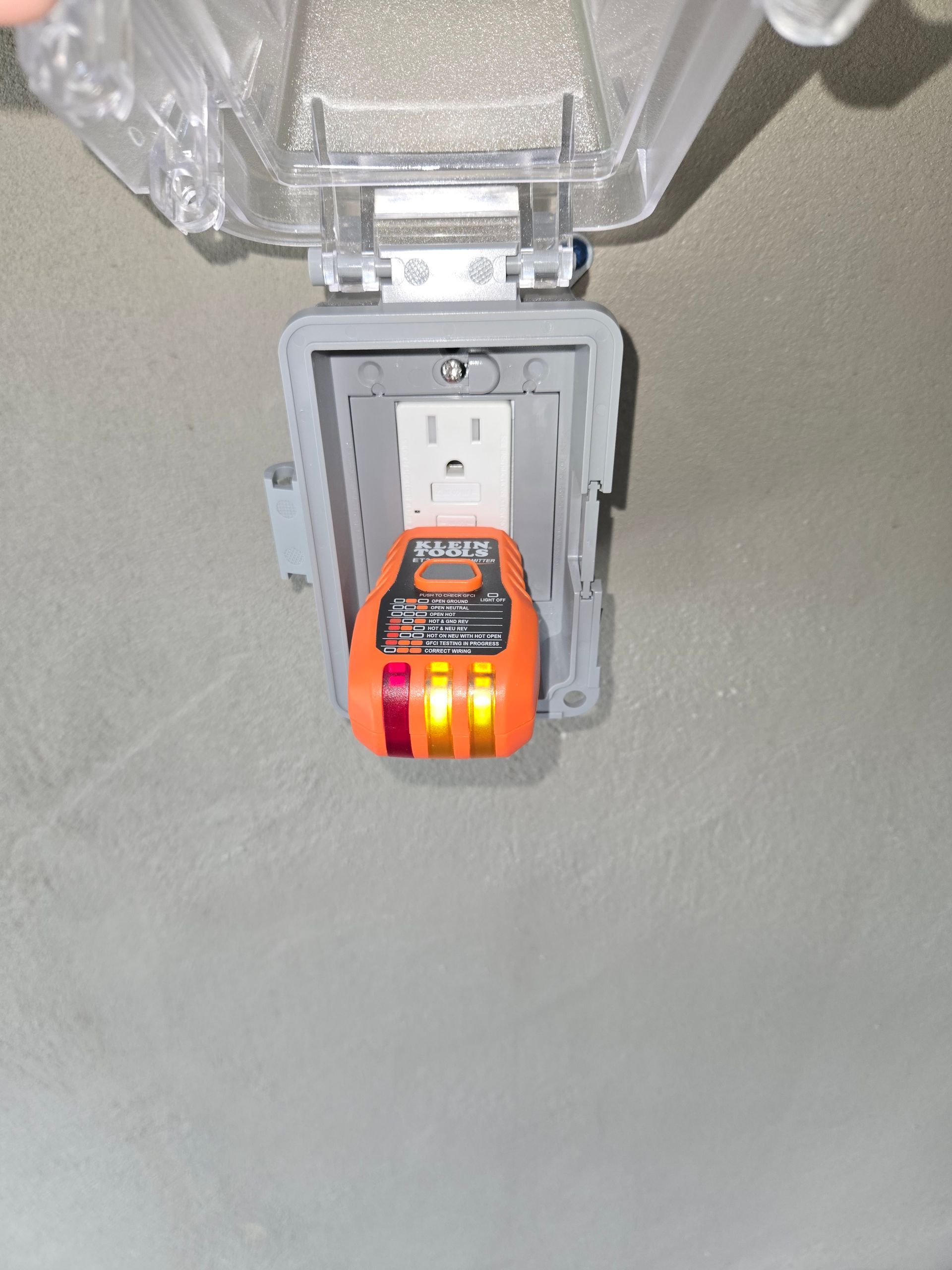 A close up of an electrical outlet with a light on it.