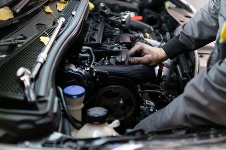 Man Working On Engine — East Longmeadow, MA — Hi-Tech Transmission Inc