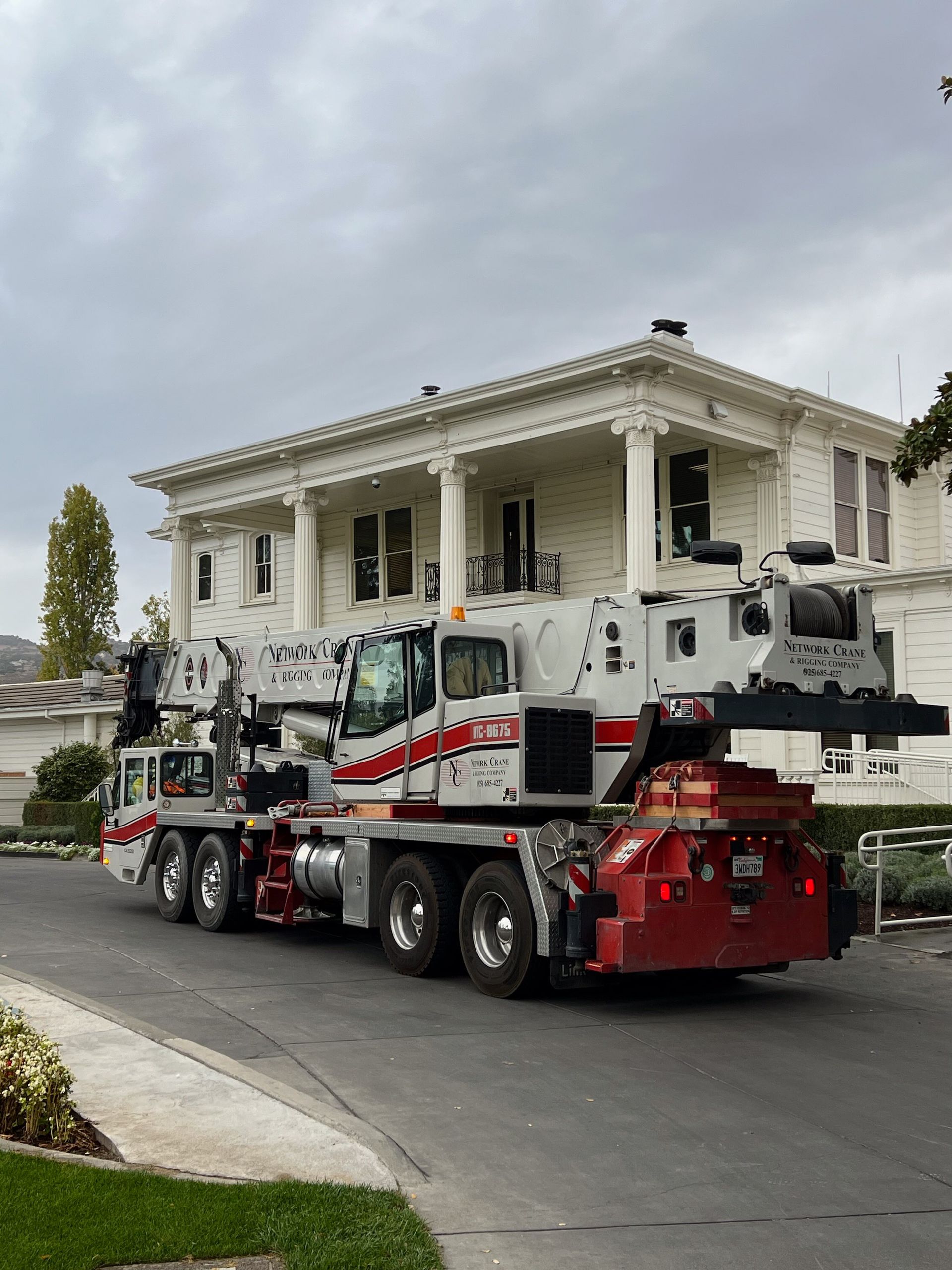 A close up of a crane hook against a blue sky