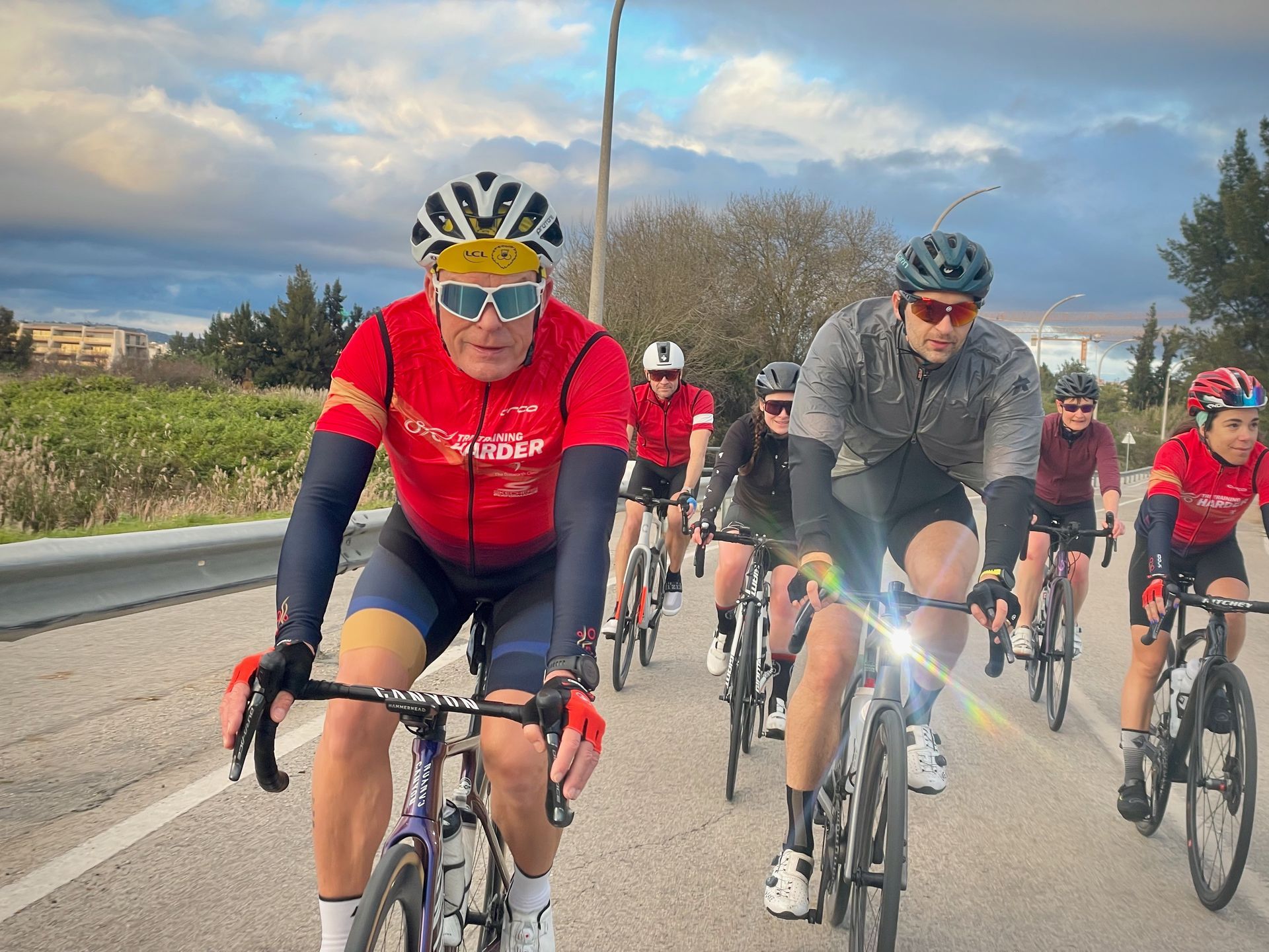 A group of people are riding bikes down a curvy road