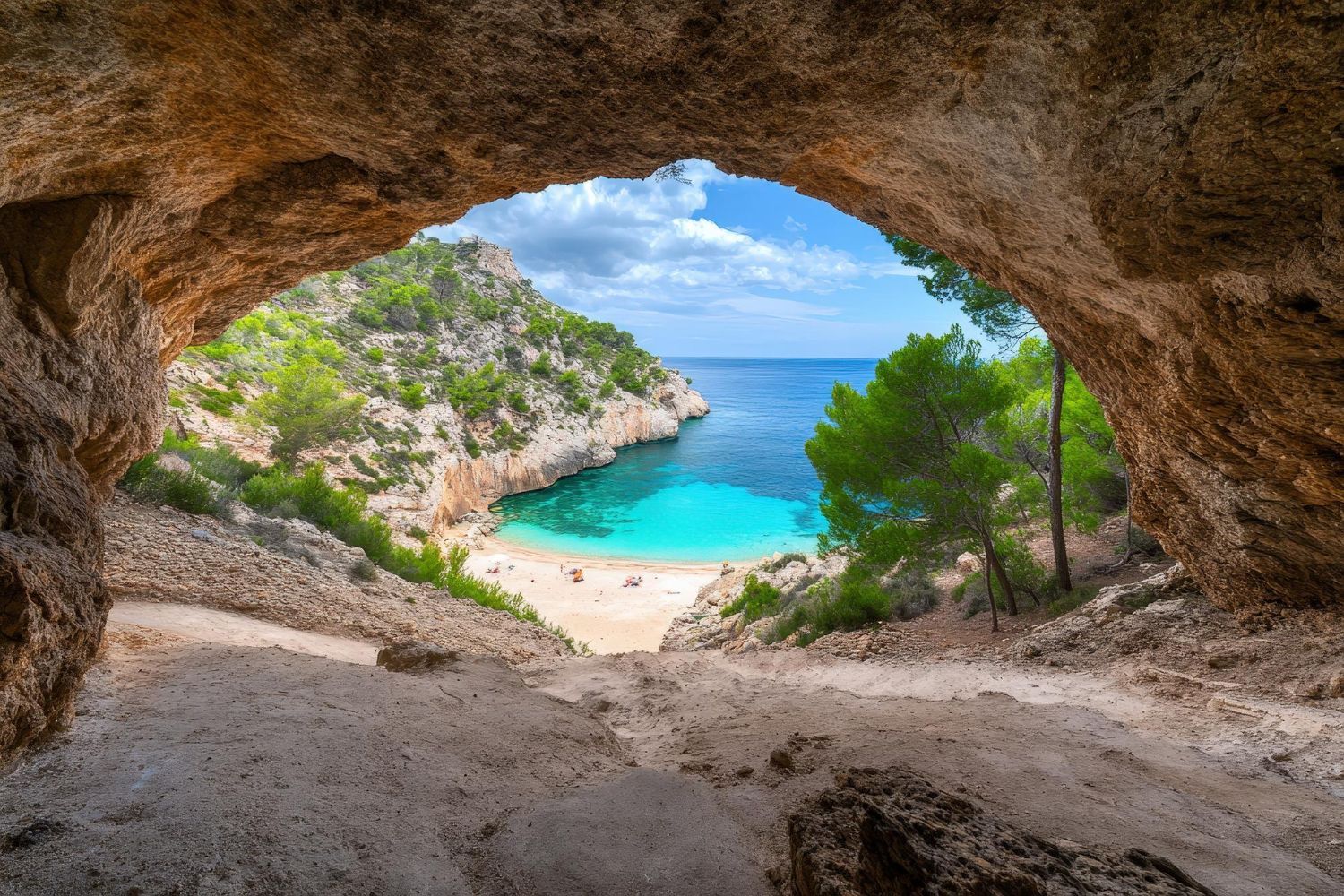 A view of a beach from inside a cave.