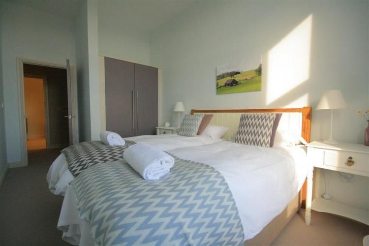 A group of people are riding bicycles down a curvy road.