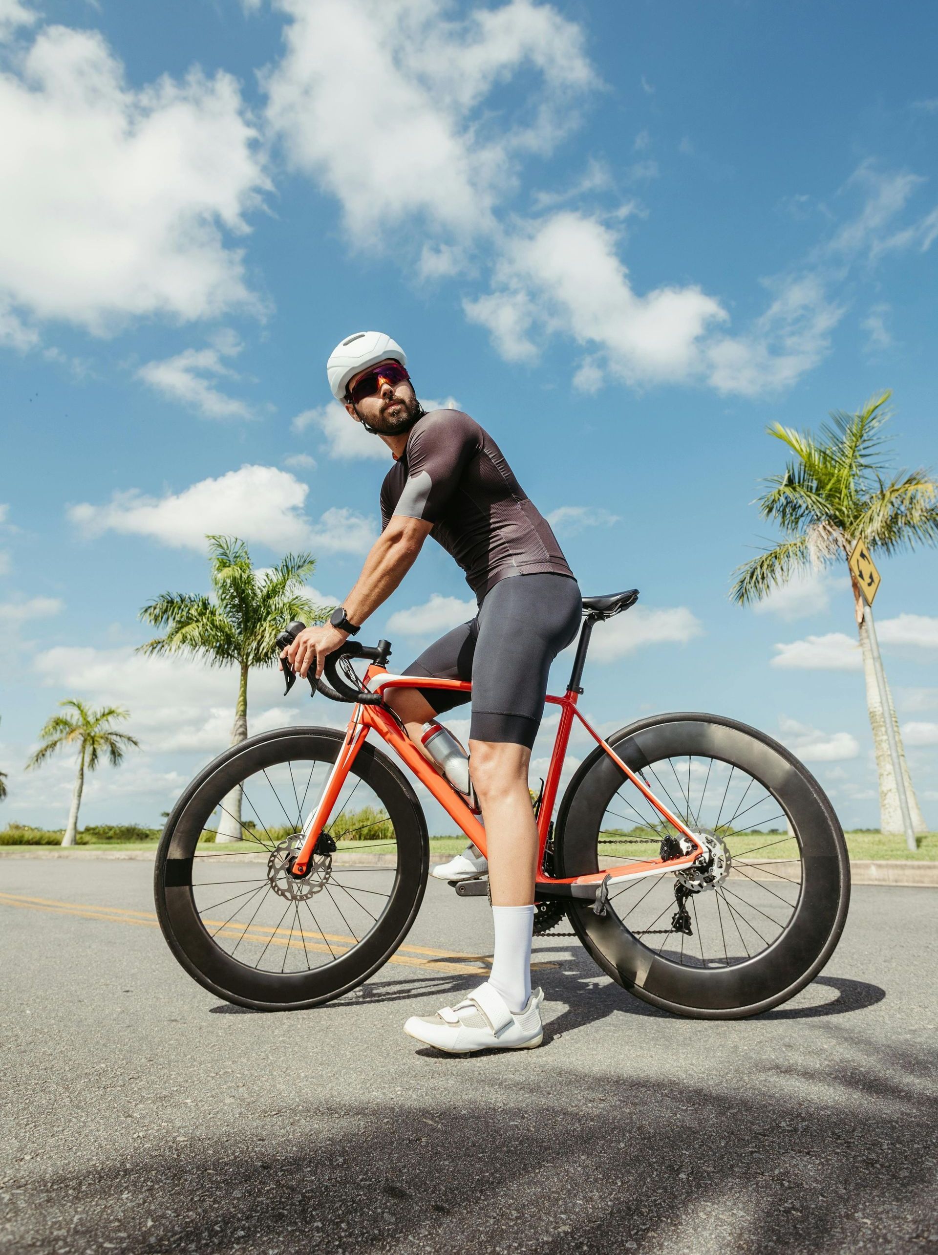 A group of people are riding bicycles down a curvy road.