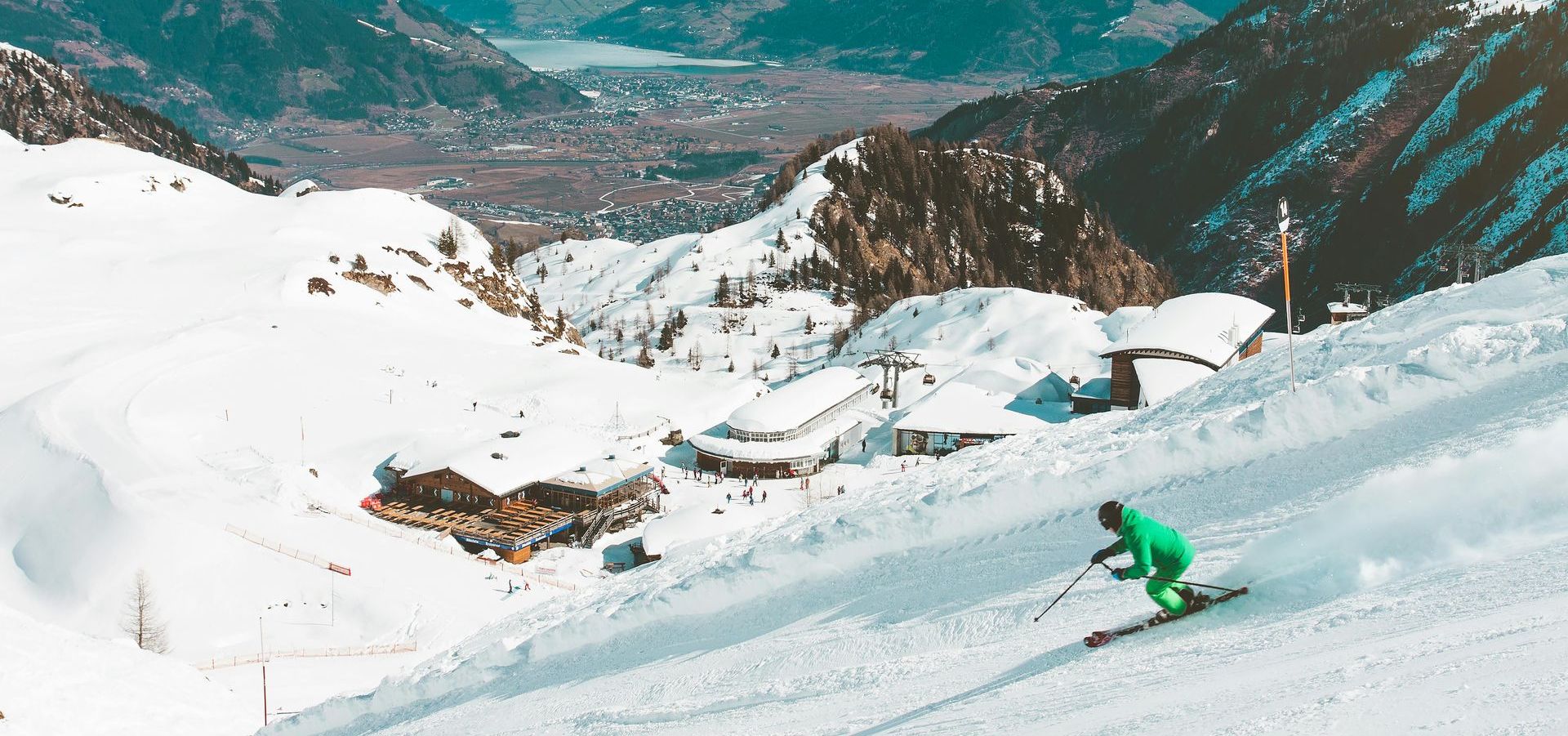 A person is skiing down a snow covered mountain.