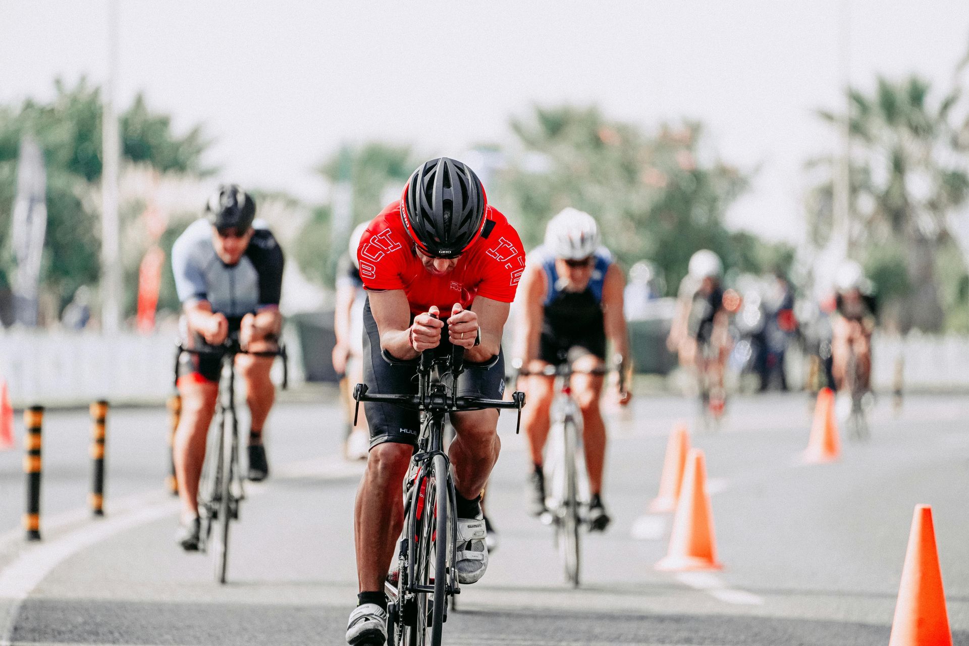A group of people are riding bicycles down a road.