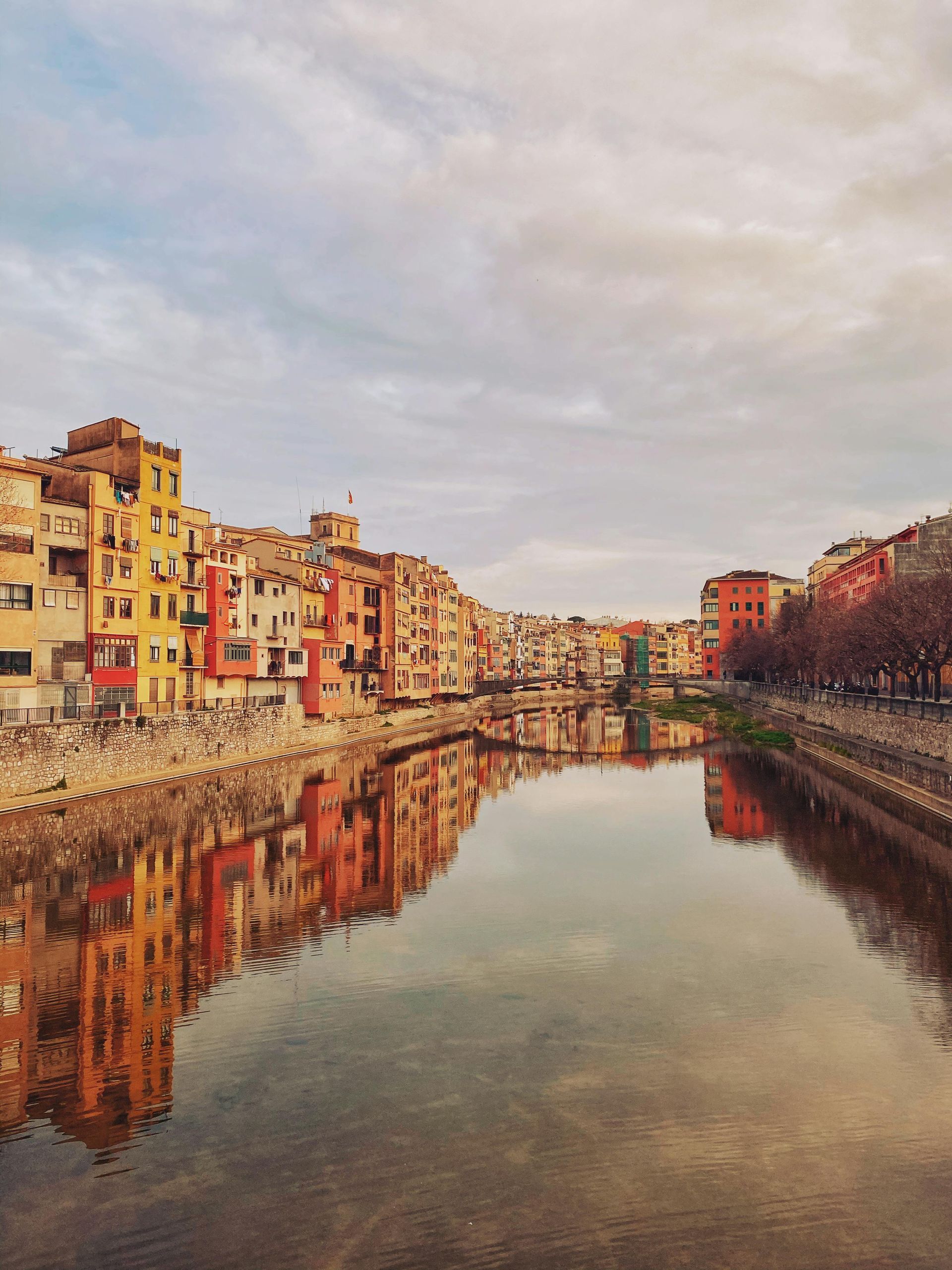 A river runs through a city with buildings on both sides of it.