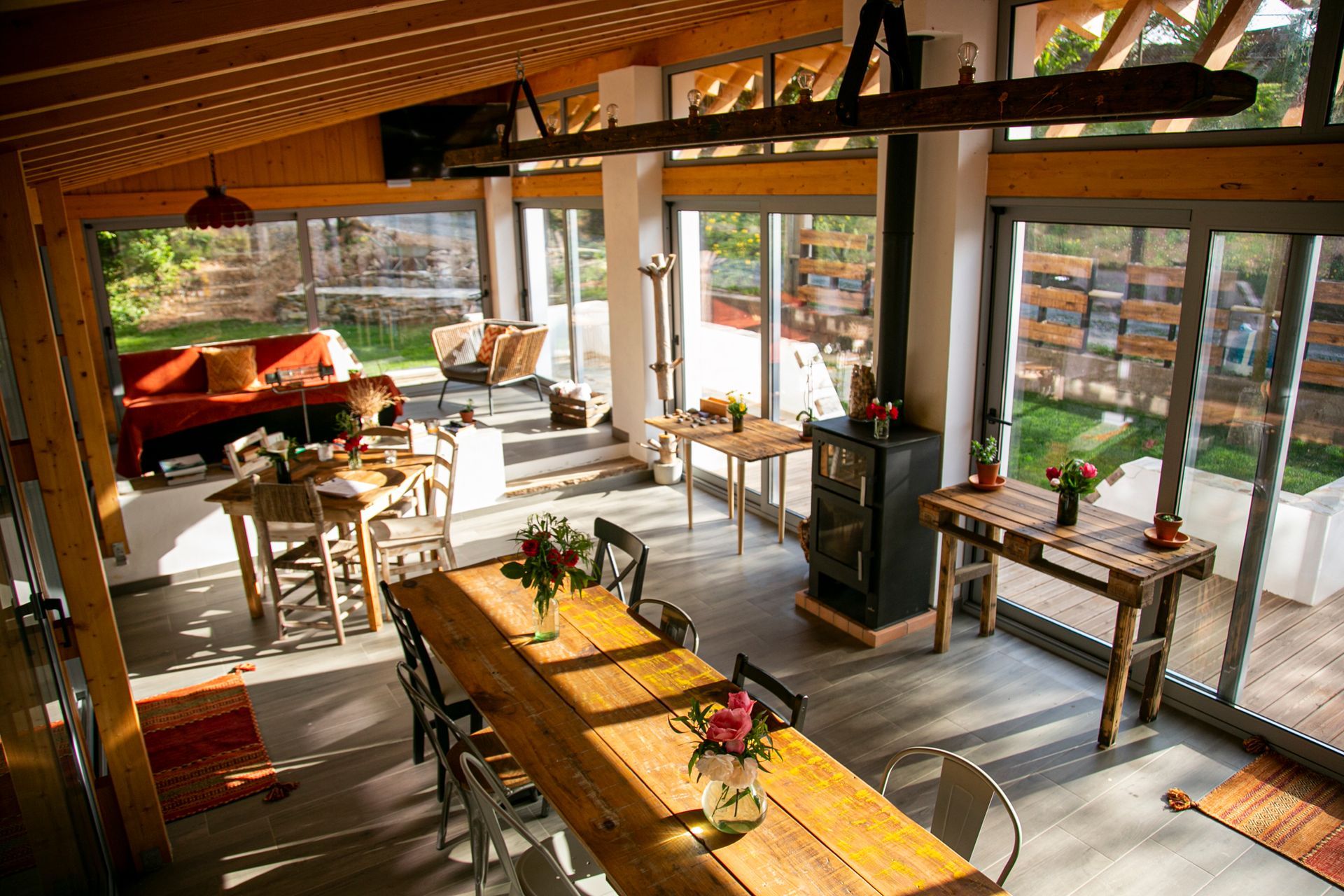 Bedroom with purple bedspread, red pillows, sliding glass door to a balcony, and a doorway to a bathroom.