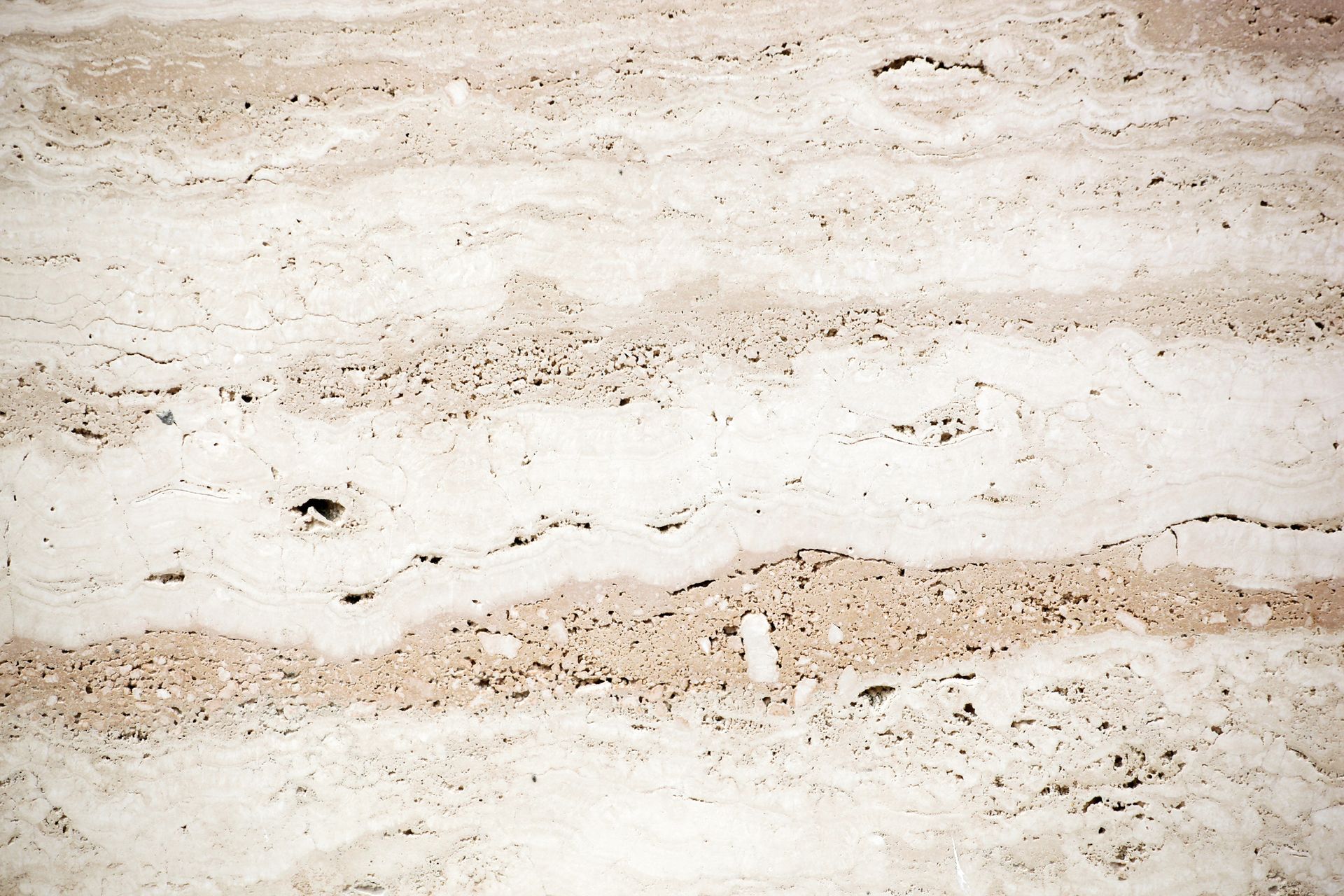 A kitchen with a shiny wooden floor and cabinets.