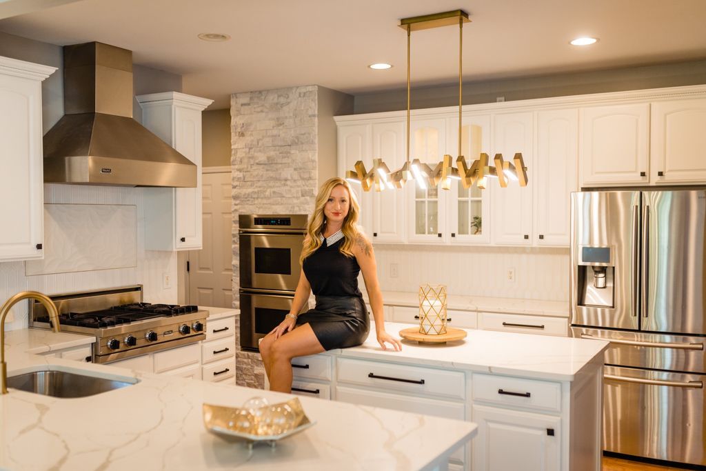 A man and a woman are standing in a kitchen looking at a tablet.