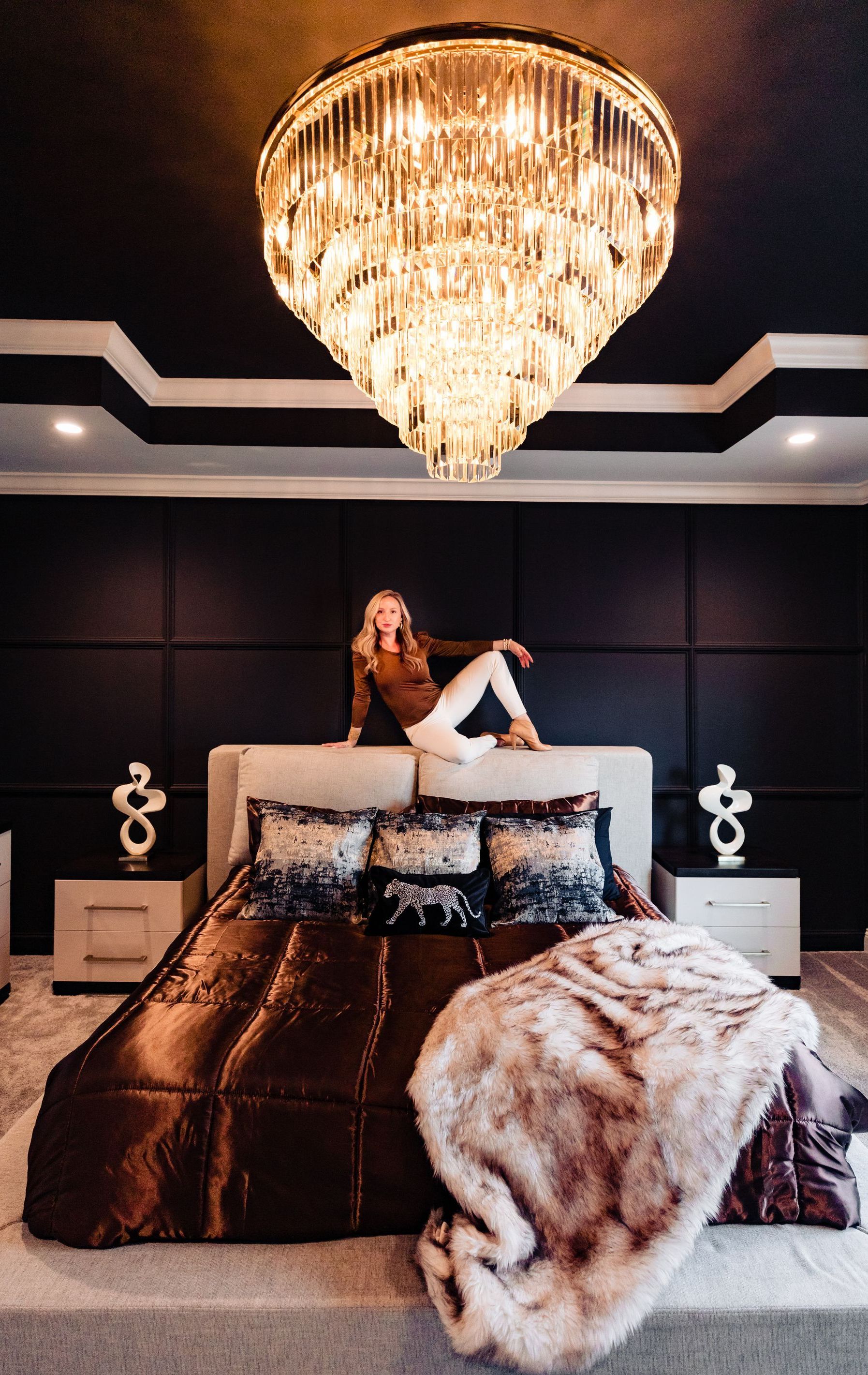 A woman is holding a piece of paper while a man is measuring a window.