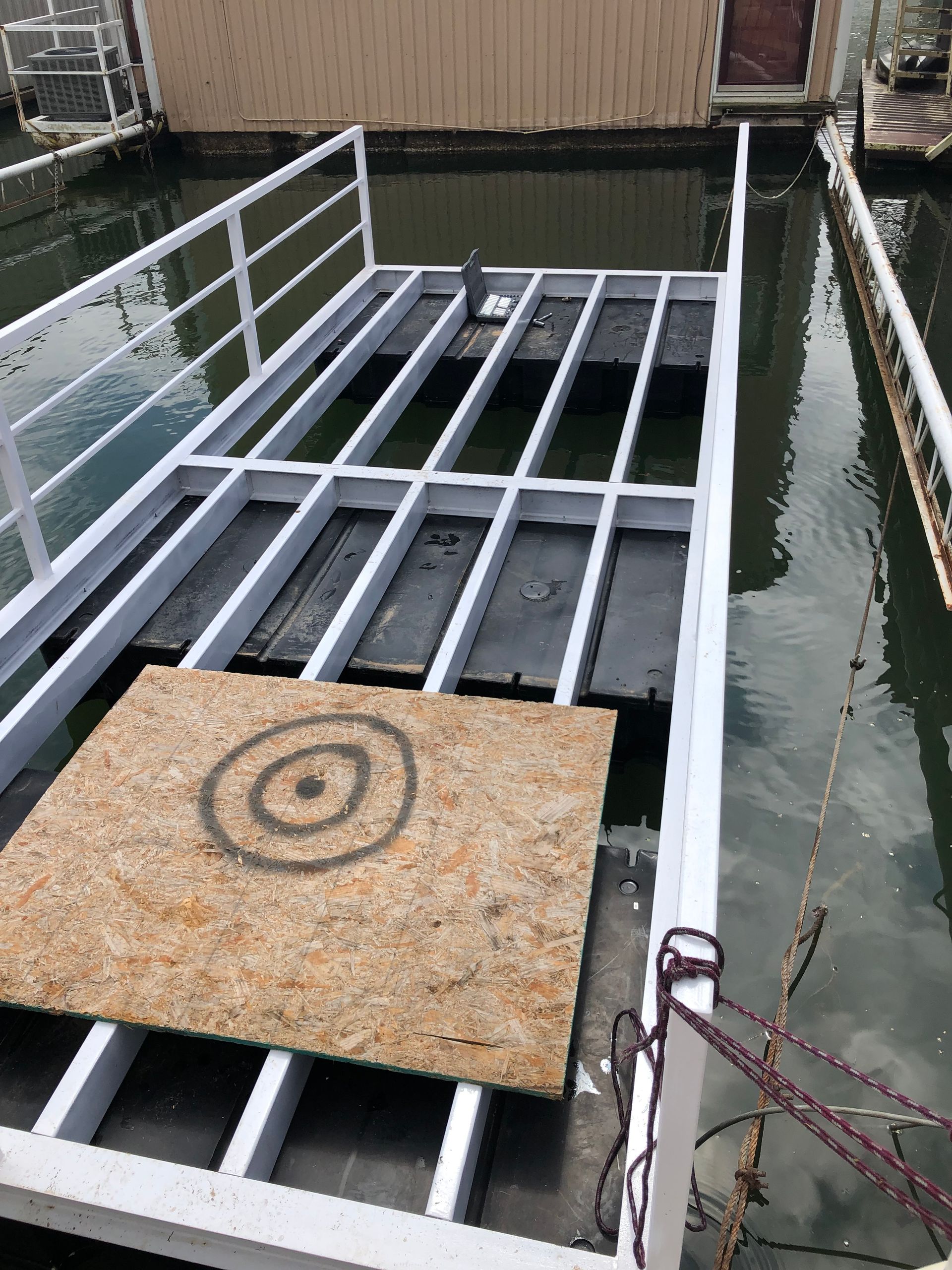 A dock with a circle on it is in the water.
