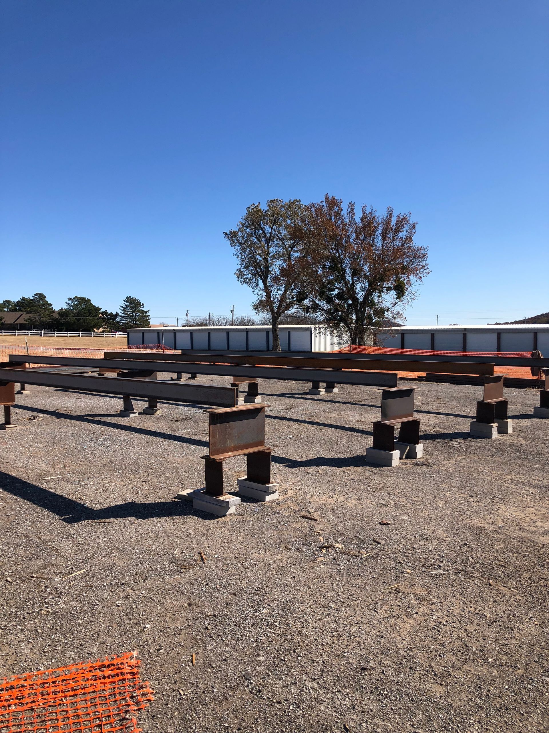 A construction site with a tree in the background