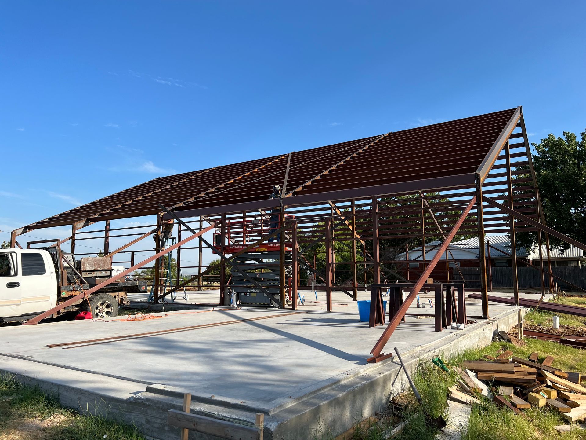 A truck is parked in front of a building under construction.