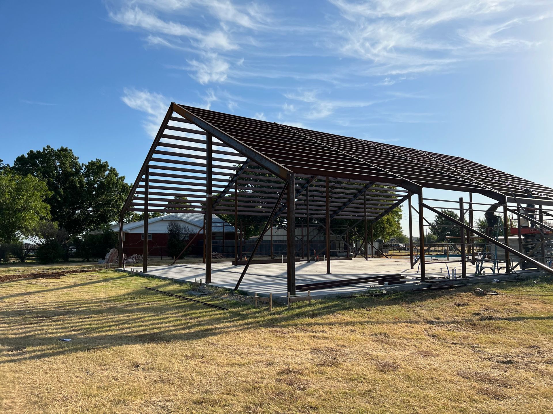 A large metal structure is sitting in the middle of a field.
