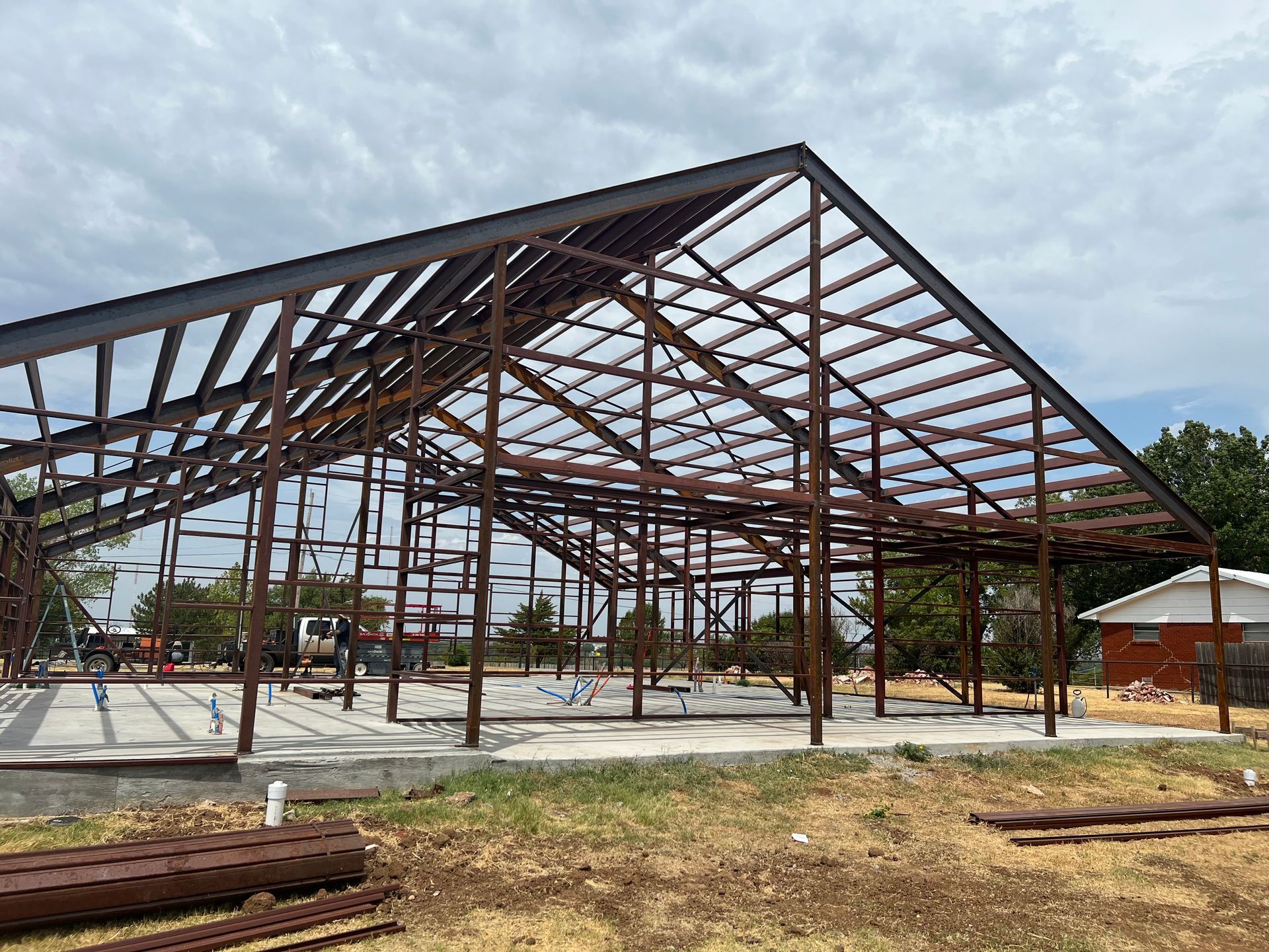 A large metal structure is being built in a field.