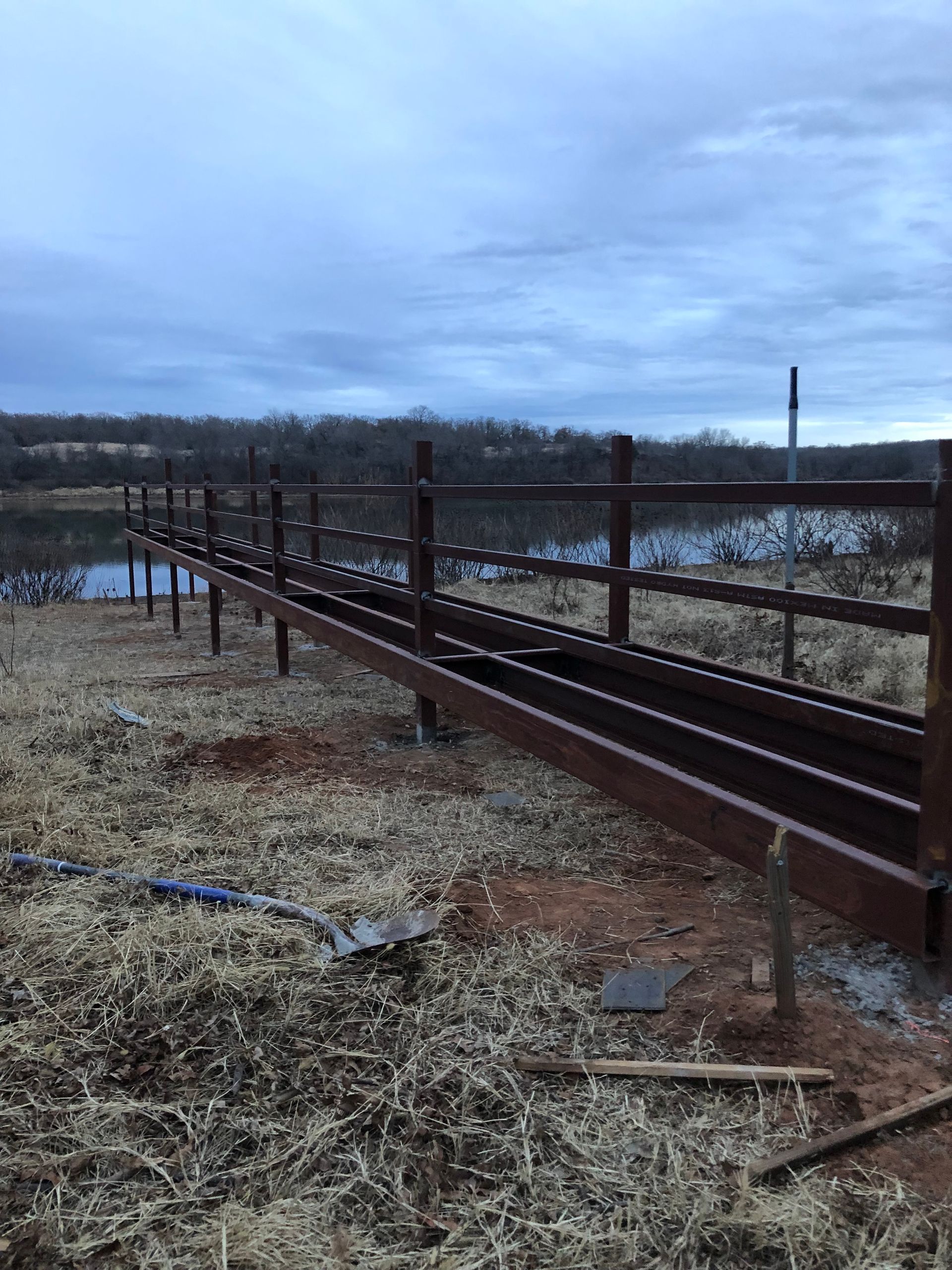 A wooden bridge is being built over a body of water.