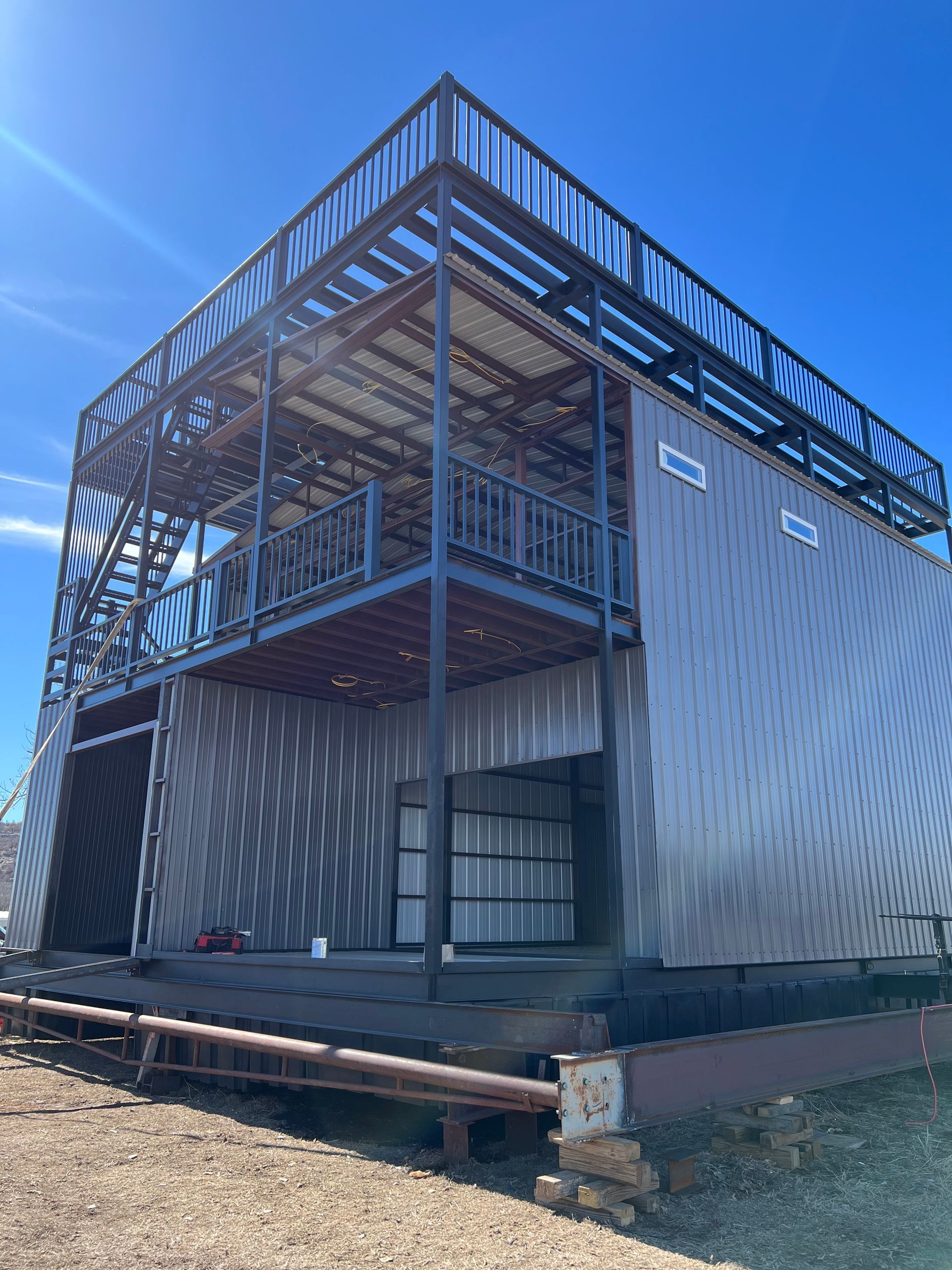 A large metal building with a balcony on top of it.