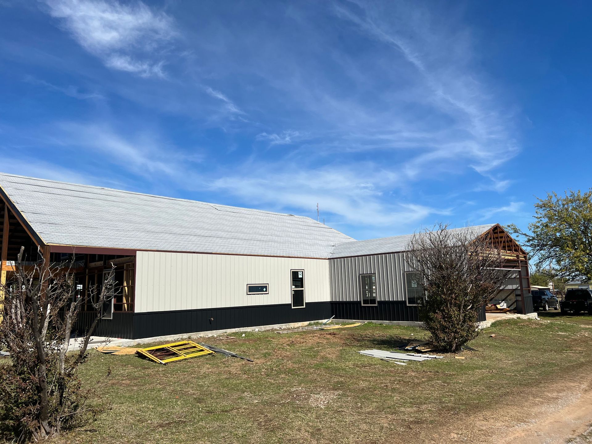 A house is being built in the middle of a grassy field.