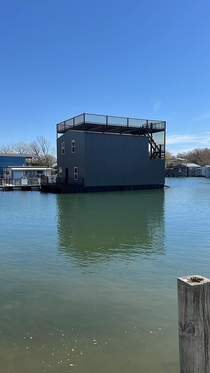 A large building is floating on top of a body of water.
