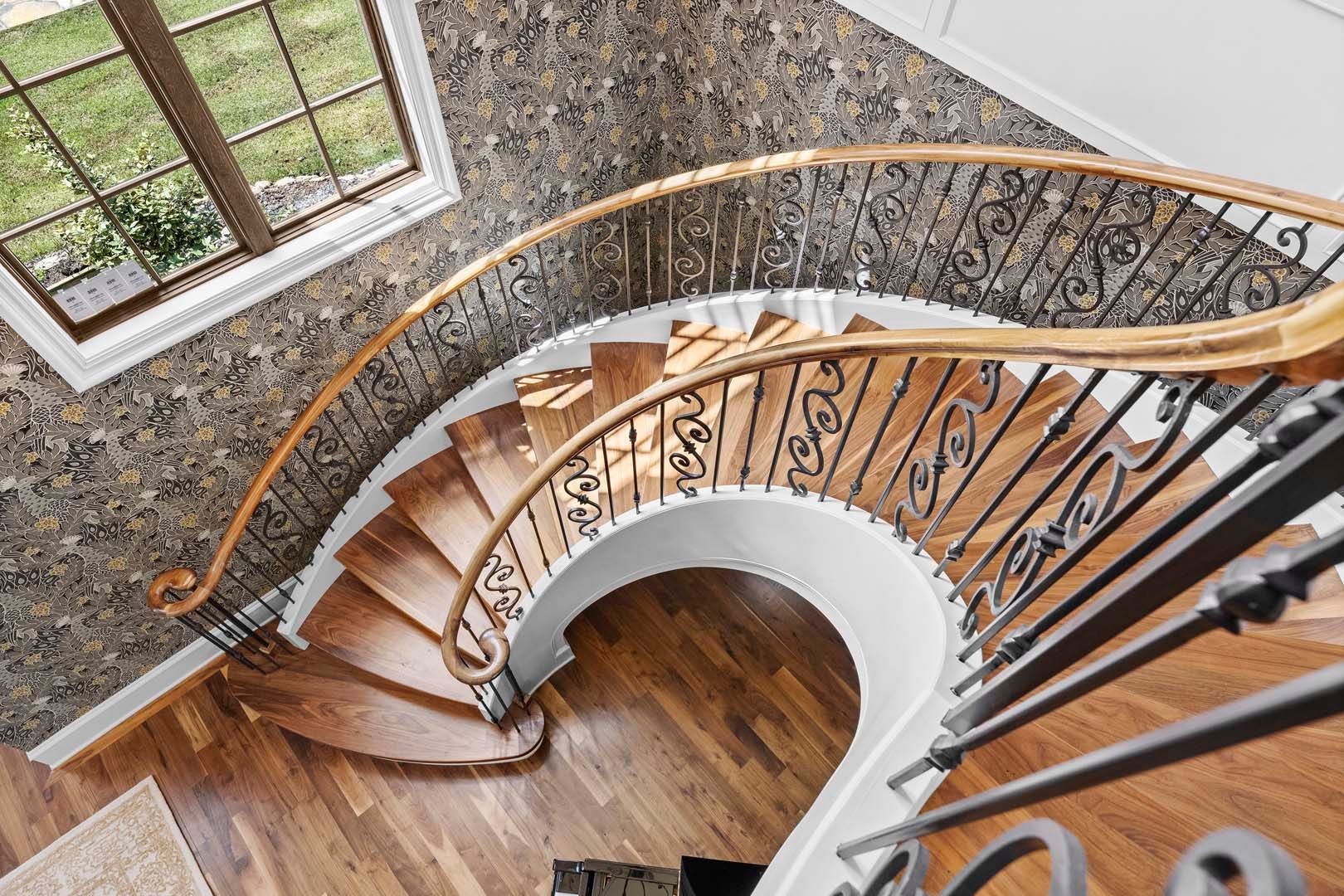 Spiral Staircase In A Home With A Window — Charlotte, NC — Harland Building Group