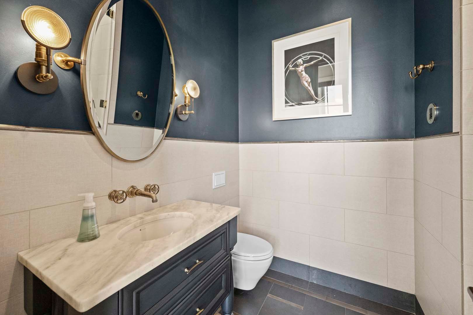 A Bathroom With Blue Walls And White Fixtures. — Charlotte, NC — Harland Building Group