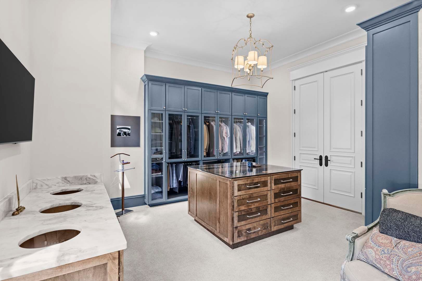 A Walk-in Closet With Blue Cabinets — Charlotte, NC — Harland Building Group