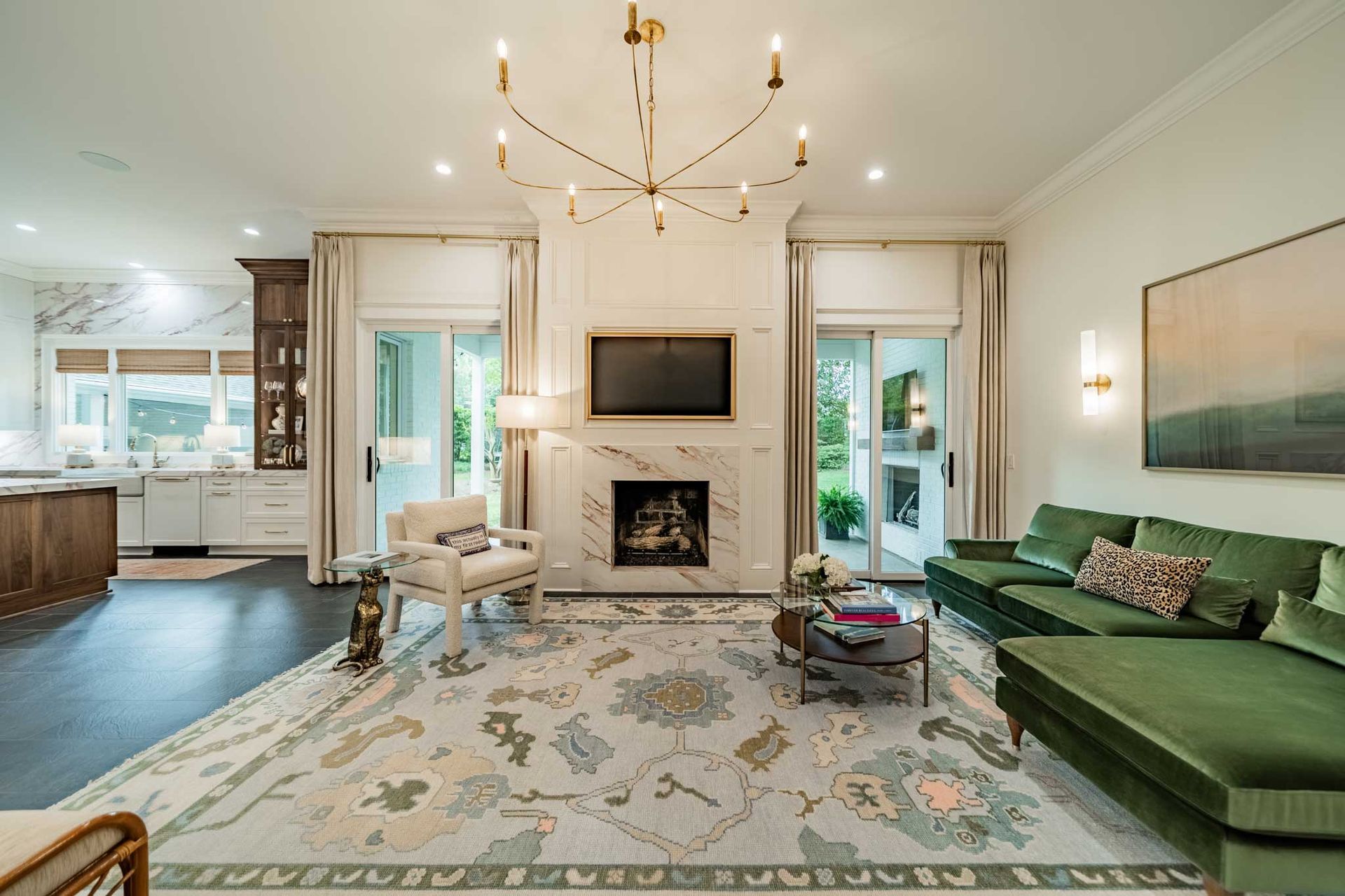 A living room with a green couch and a fireplace.