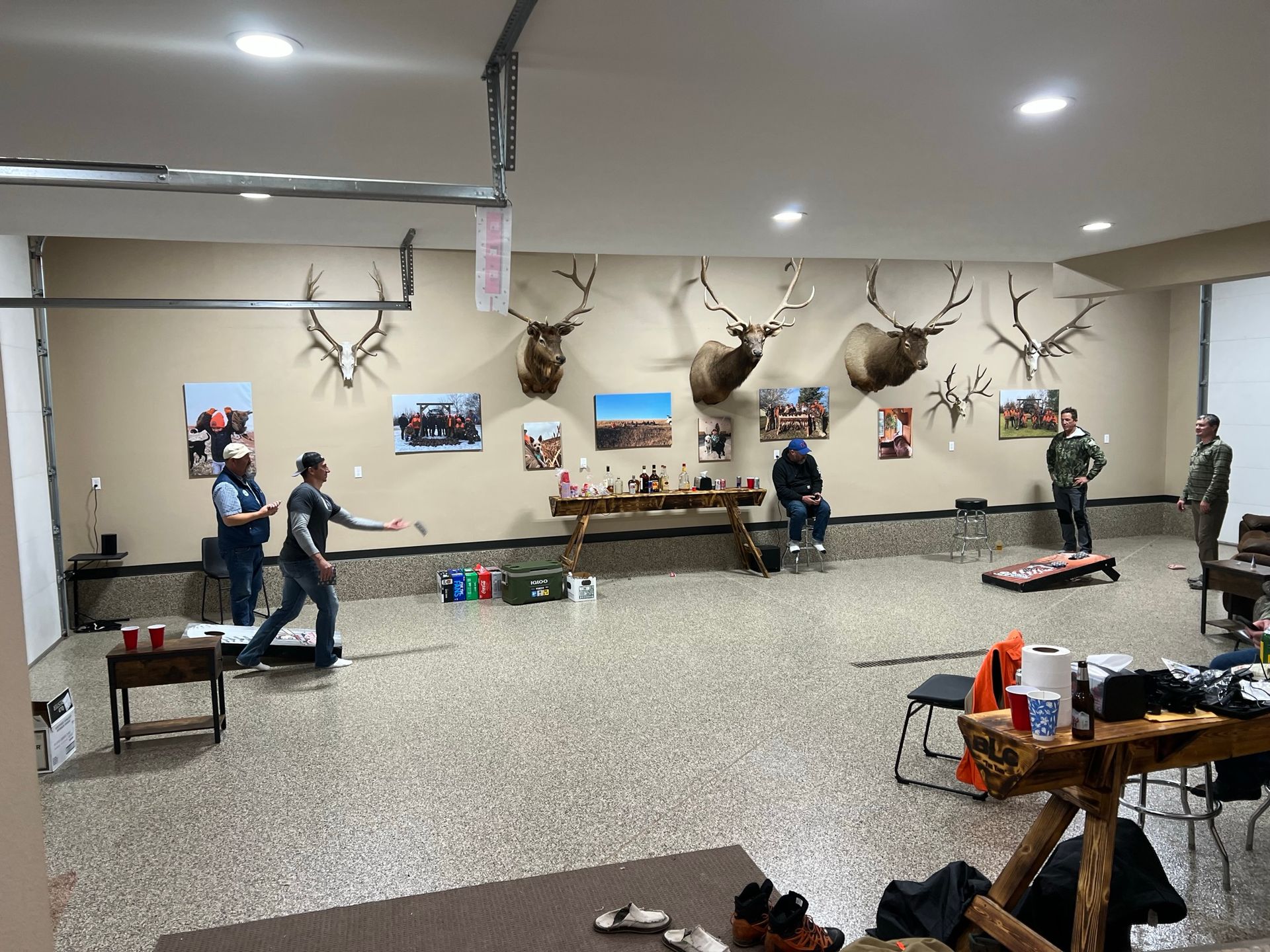 A group of people are playing a game of bocce ball in a garage.