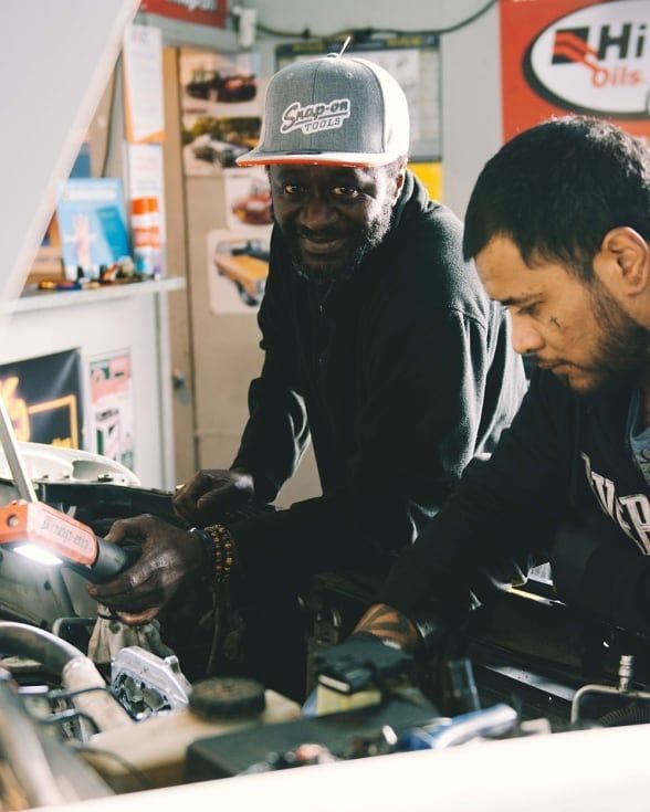 A Man Wearing A Snap On Hat Is Working On A Car — North Geelong Automotive In North Geelong, VIC