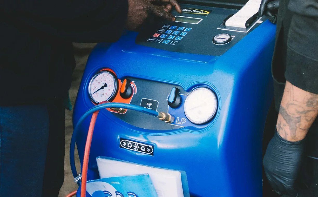 A Man Is Working On A Air Condition For The Car — North Geelong Automotive In North Geelong, VIC