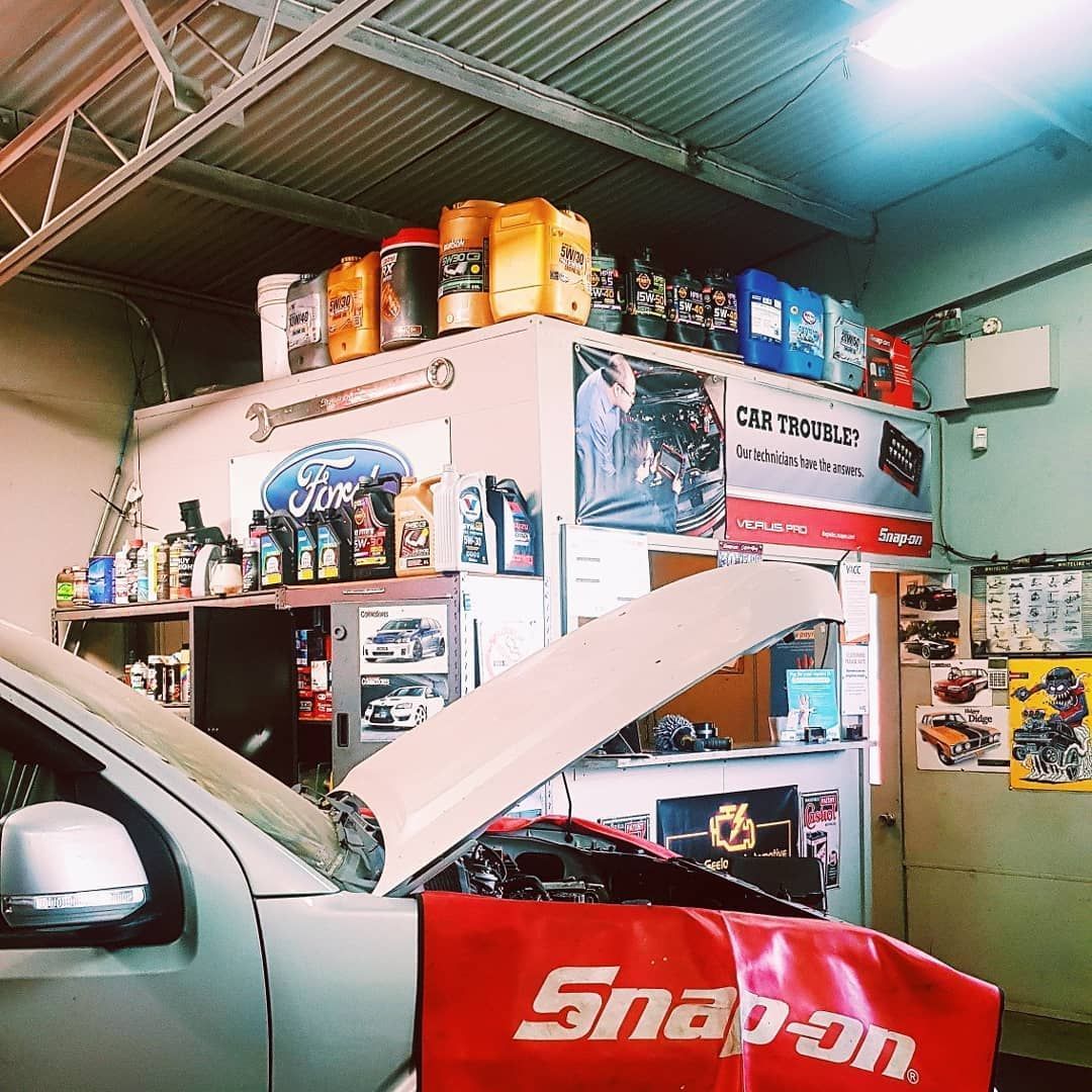 A Car Is Being Worked On In A Garage With A Snap-on Cover On The Hood — North Geelong Automotive In North Geelong, VIC