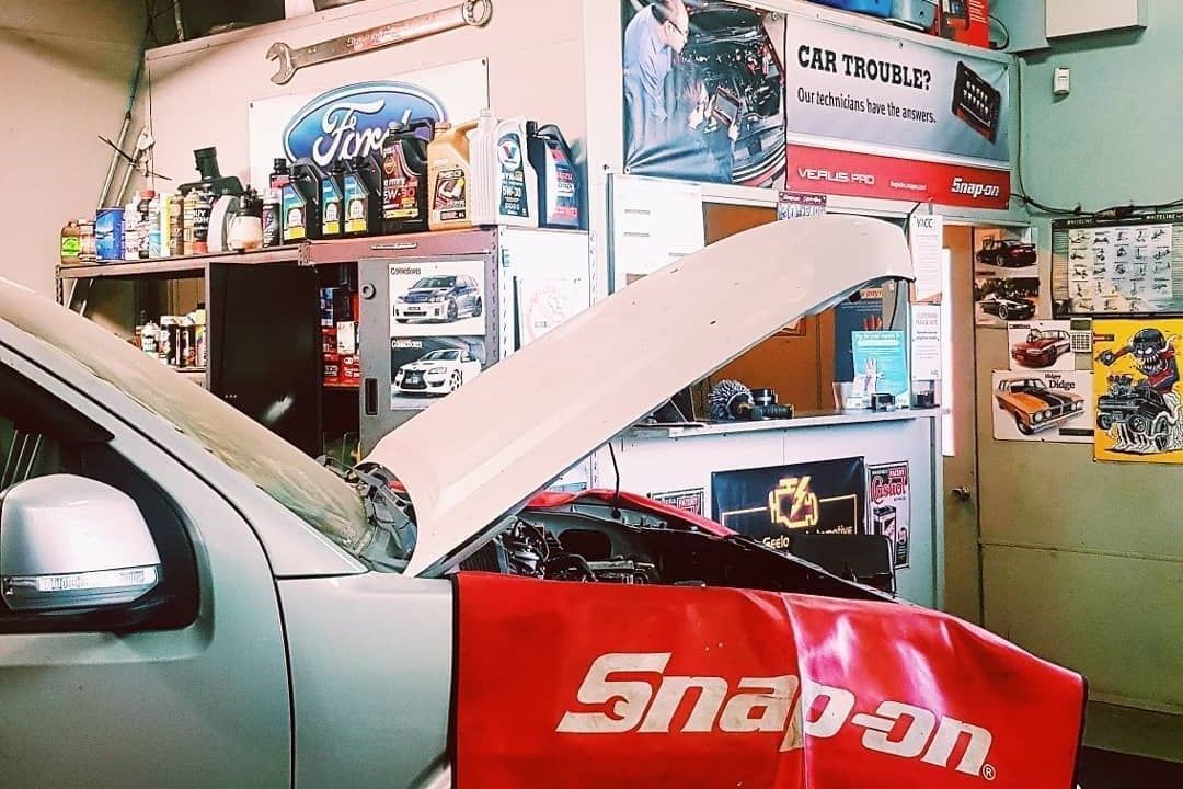 A Car On The Mechanic Shop Having Engine Inspection