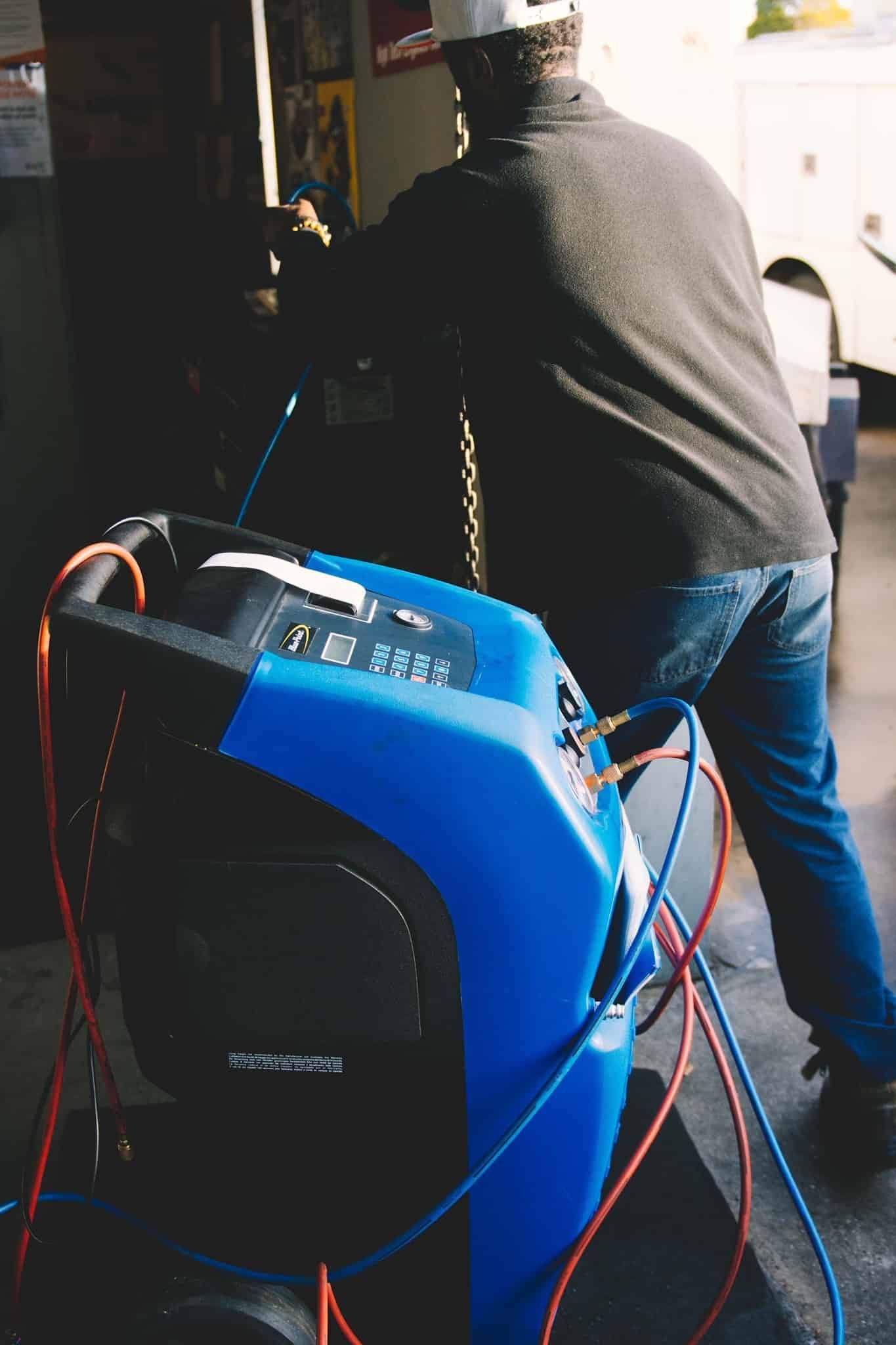 A Man Is Working On A Machine In A Garage — North Geelong Automotive In North Geelong, VIC
