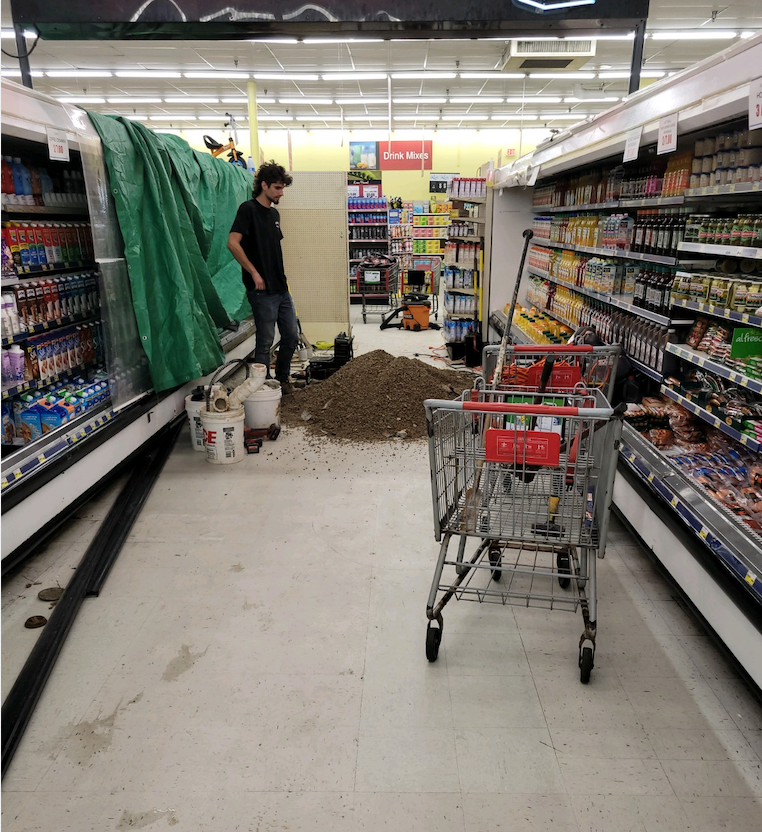 Digging up floor at Marcs Grocery to repair sewer line.