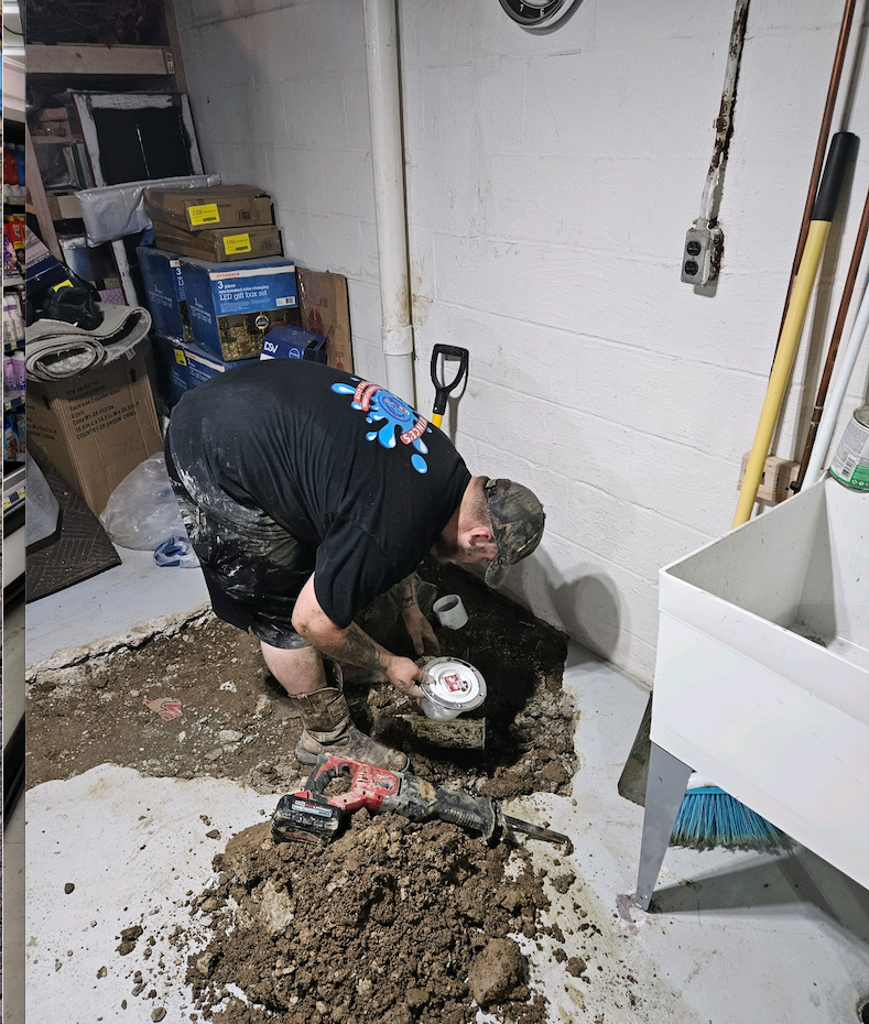 Plumber installing floor trap.