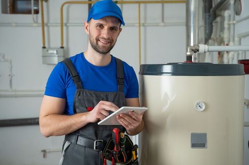 Plumber repairing water heater.