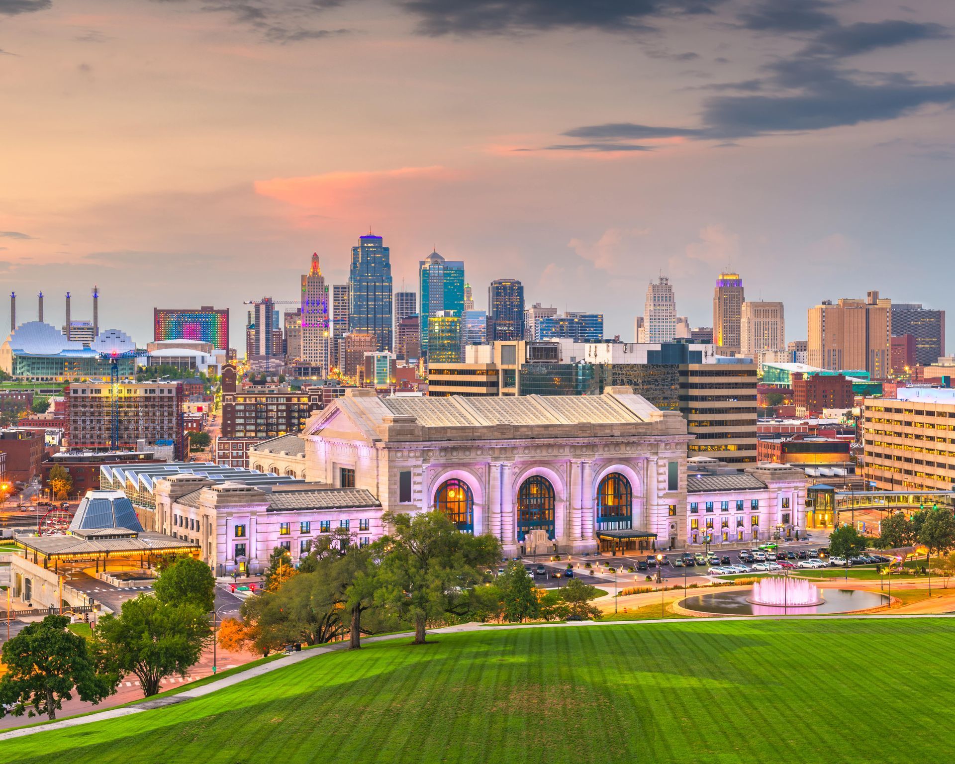 An aerial view of a city skyline with a large building in the foreground.
