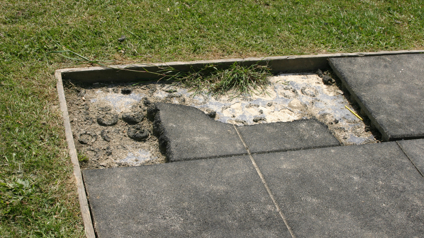 a piece of concrete is laying on the ground in the grass