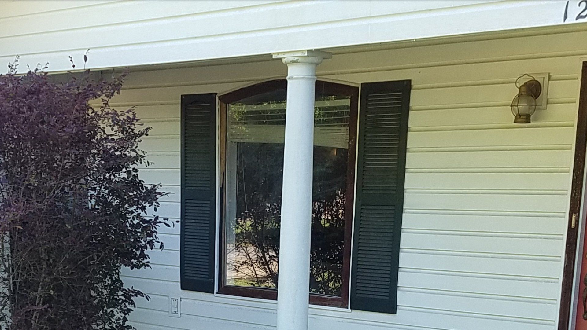 A white house with black shutters on the windows