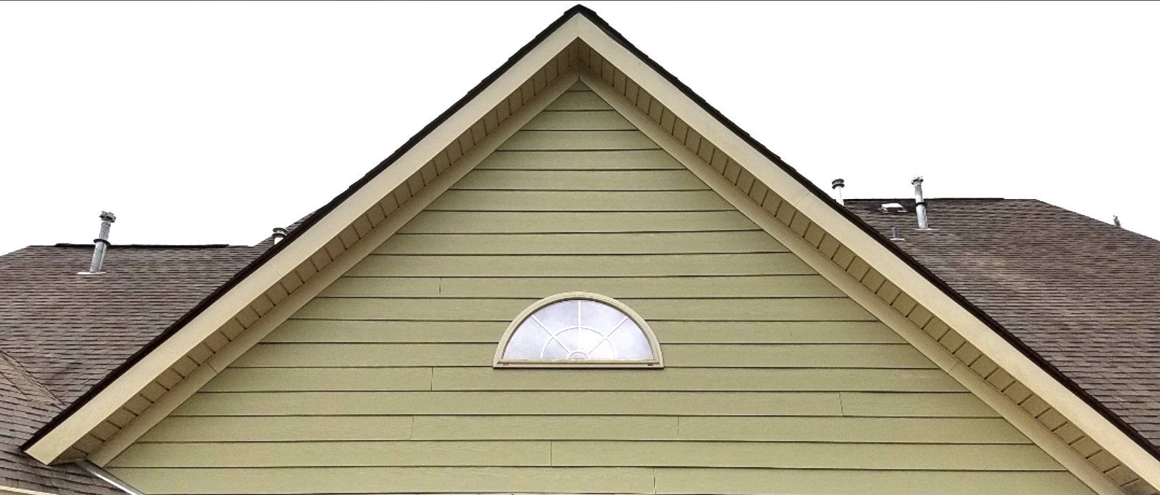 A house with a triangle shaped roof and a window