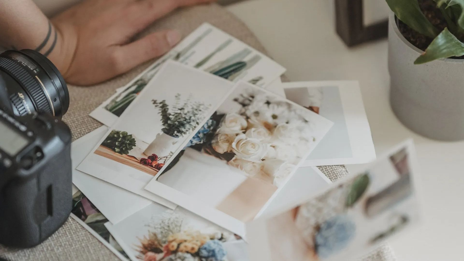 a bunch of pictures and a wallet on a table