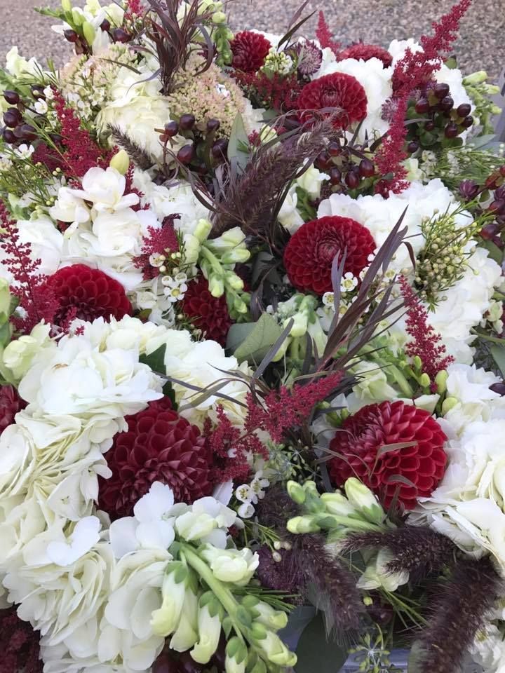 a large bouquet of white and red flowers