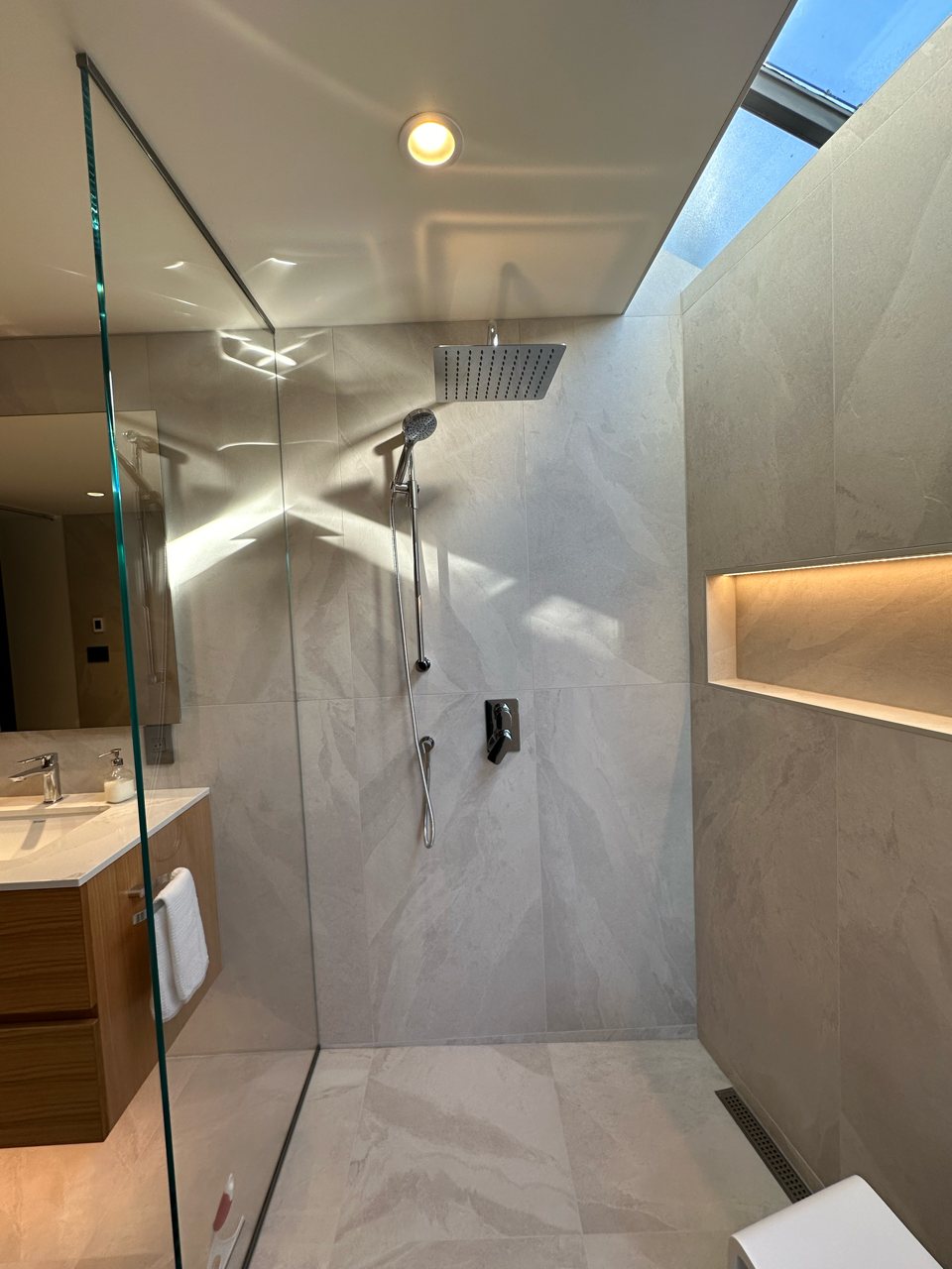 A bathroom with a walk in shower and a toilet