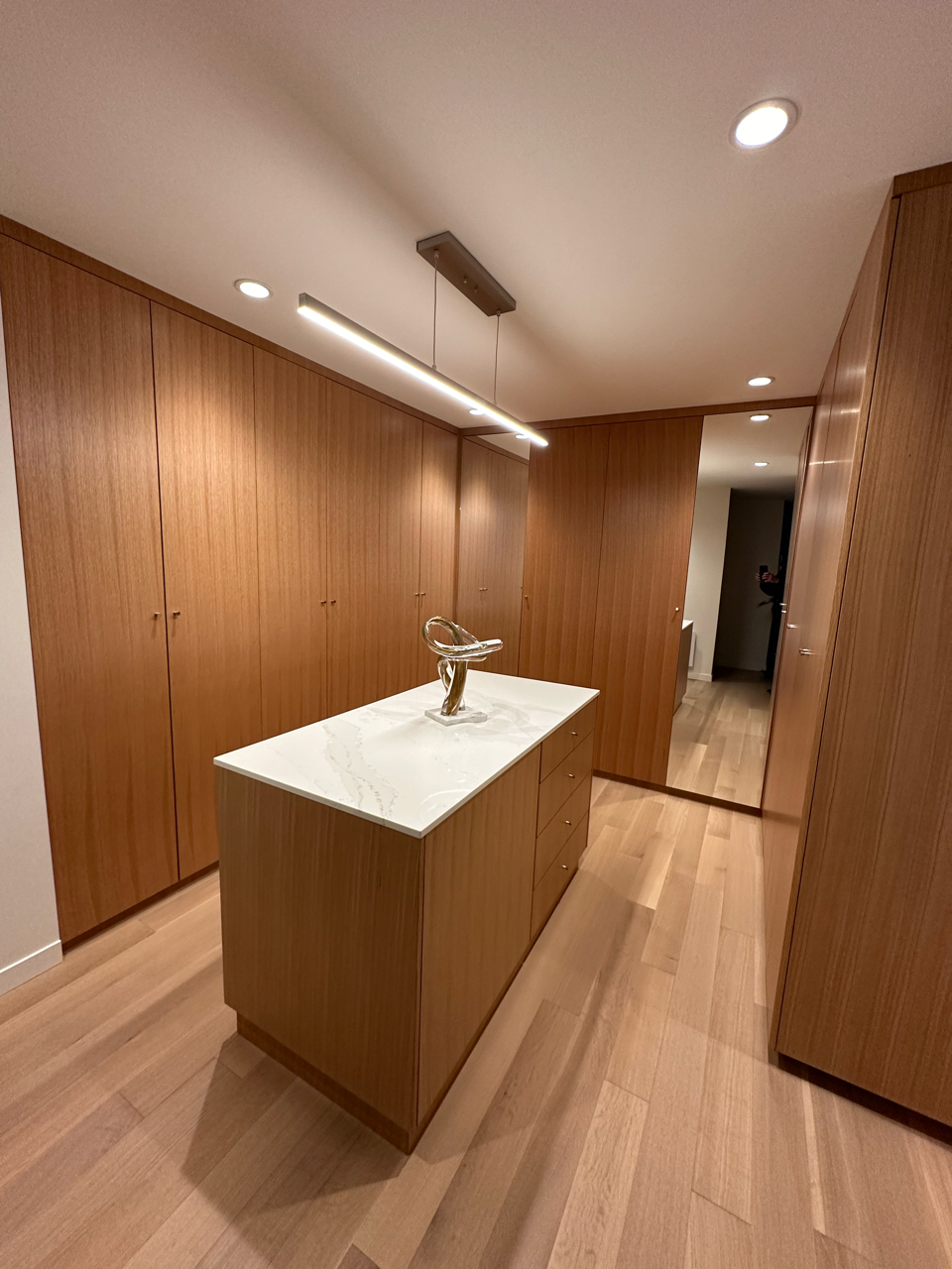 A bathroom with a large island and a mirror