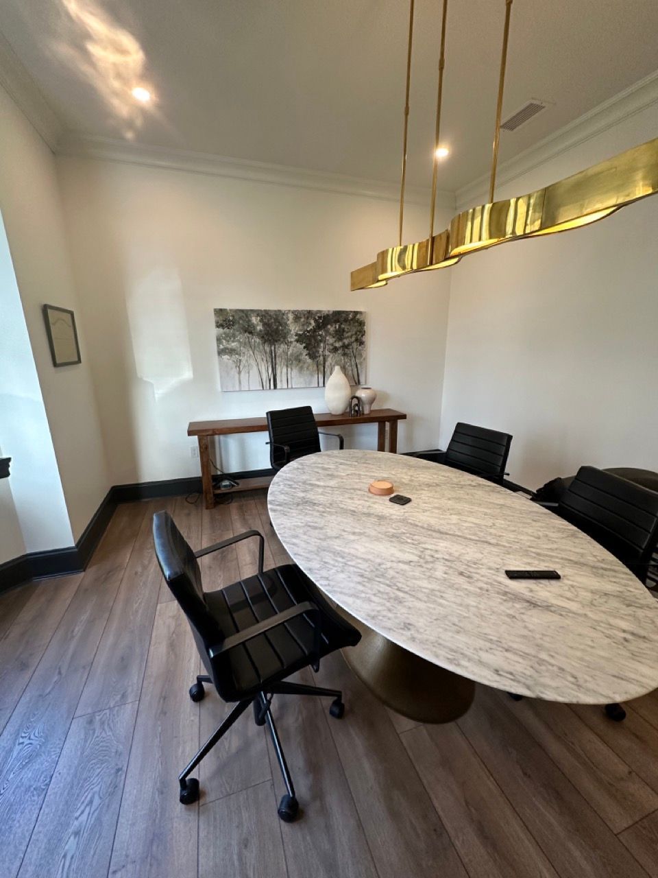 A conference room with a large marble table and chairs.