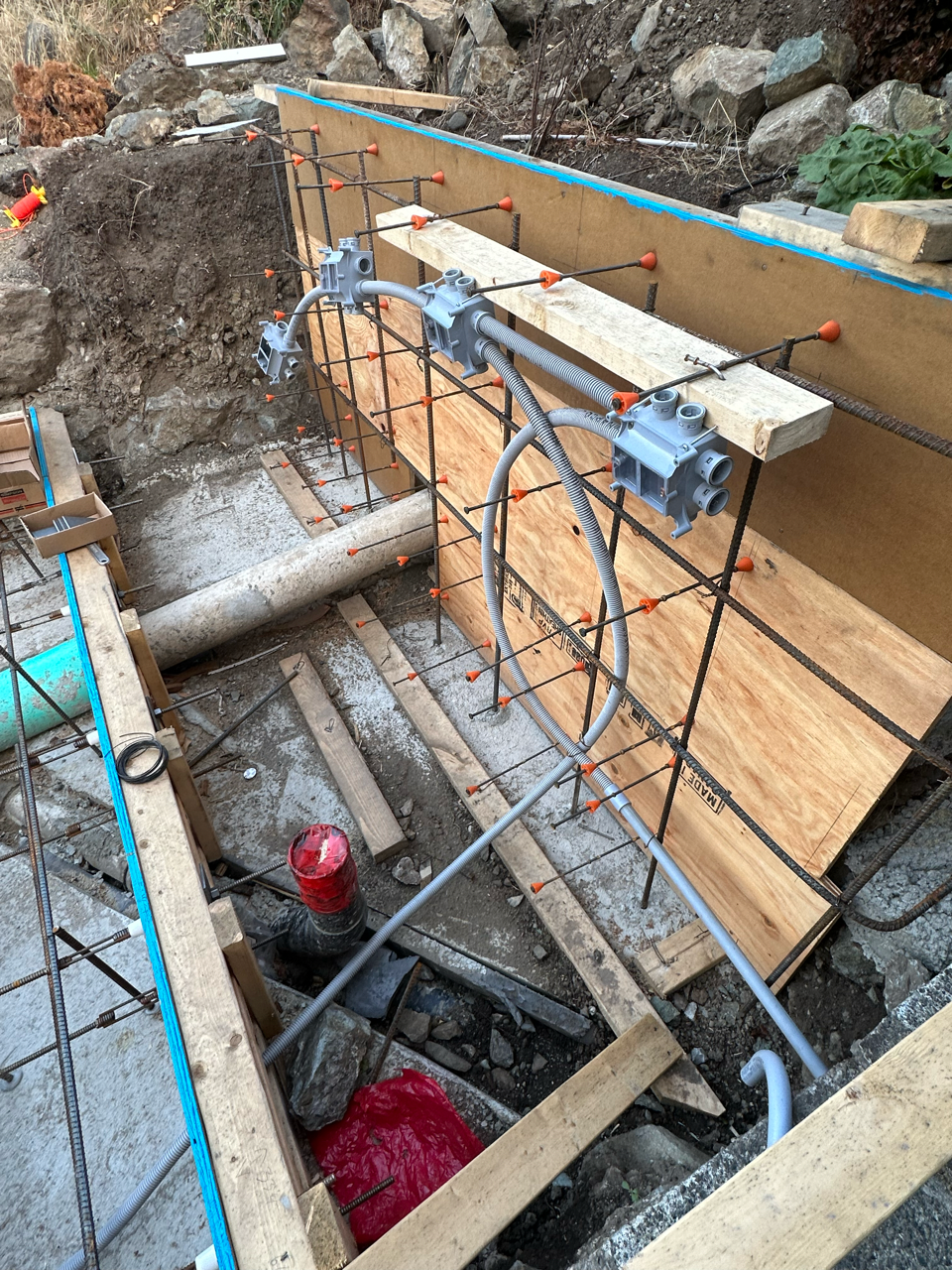 A concrete wall is being built in a hole in the ground.