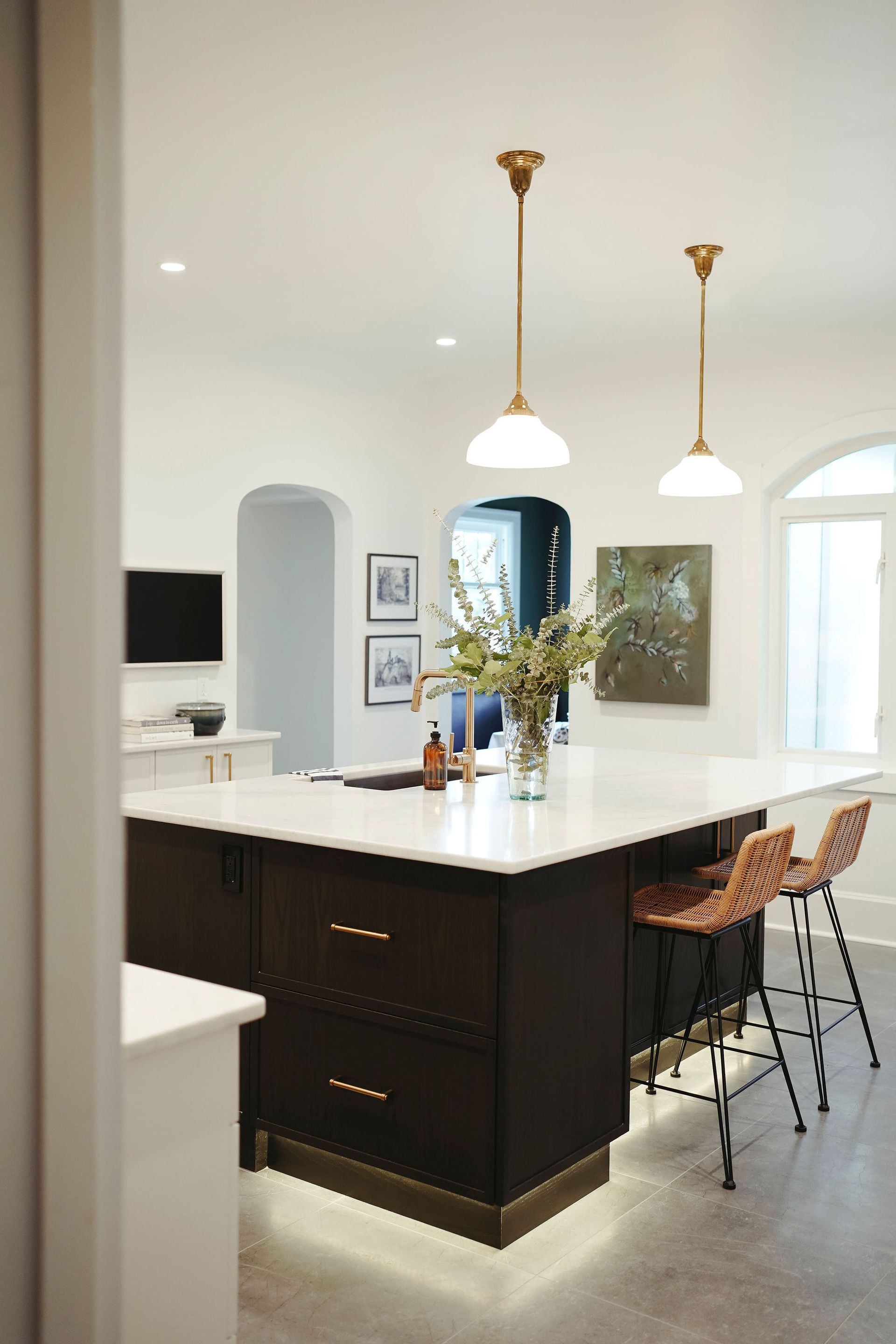 A kitchen with a large island and stools.