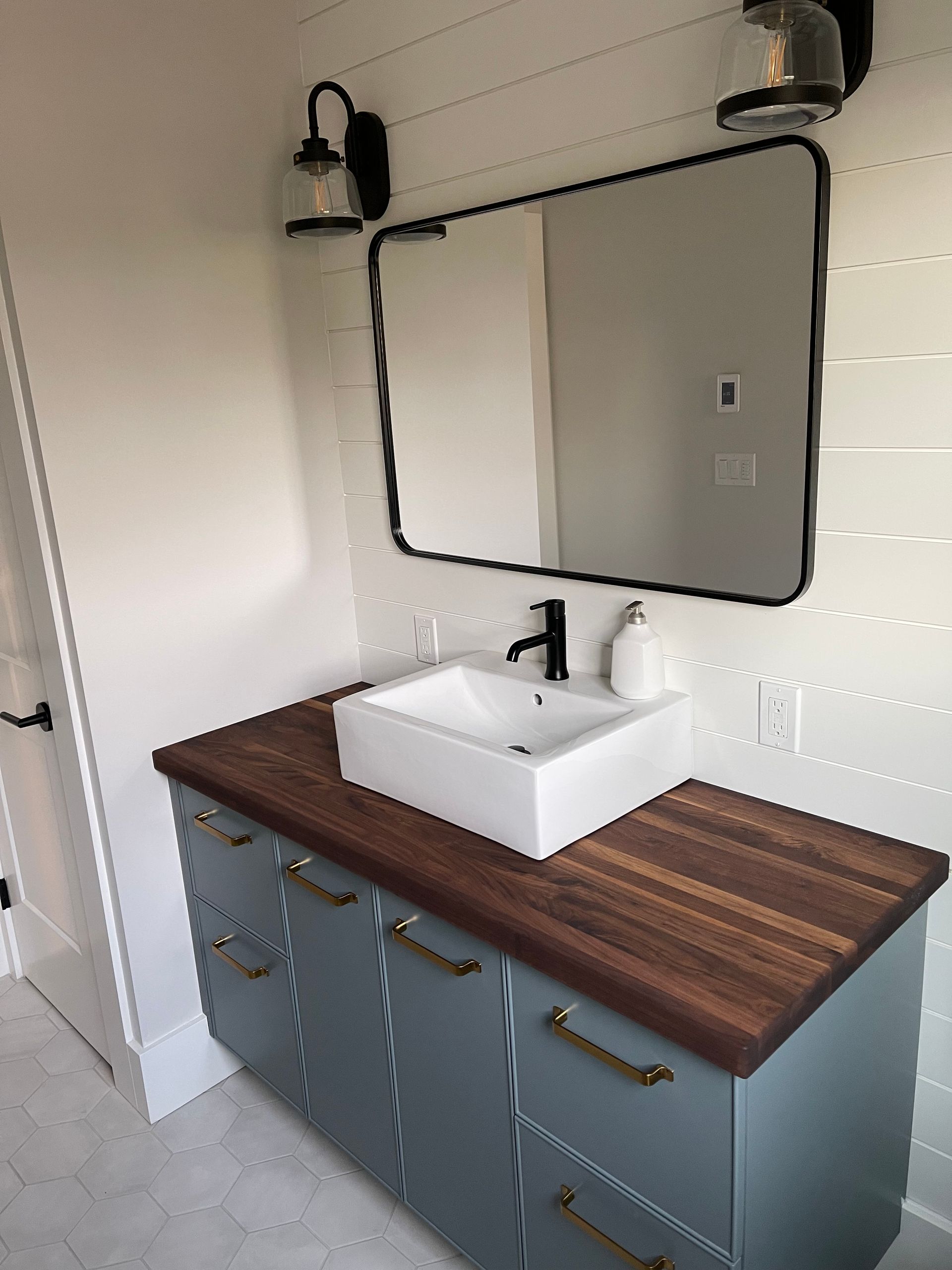 A bathroom vanity with a sink and a mirror
