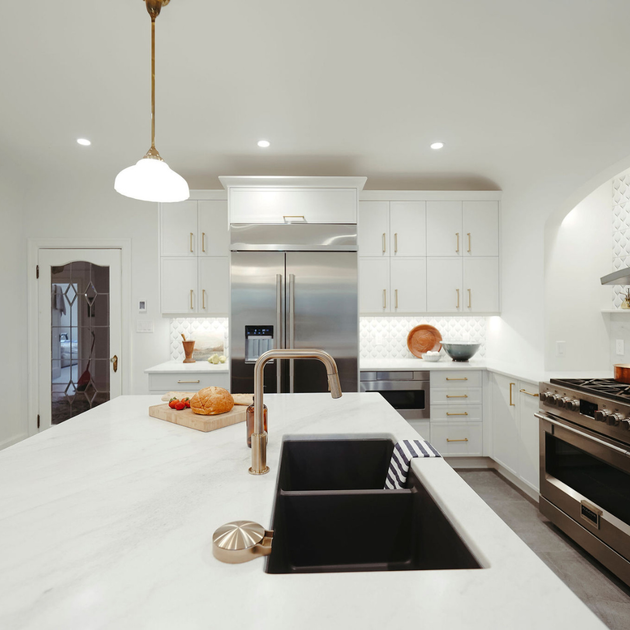 A kitchen with white cabinets and stainless steel appliances