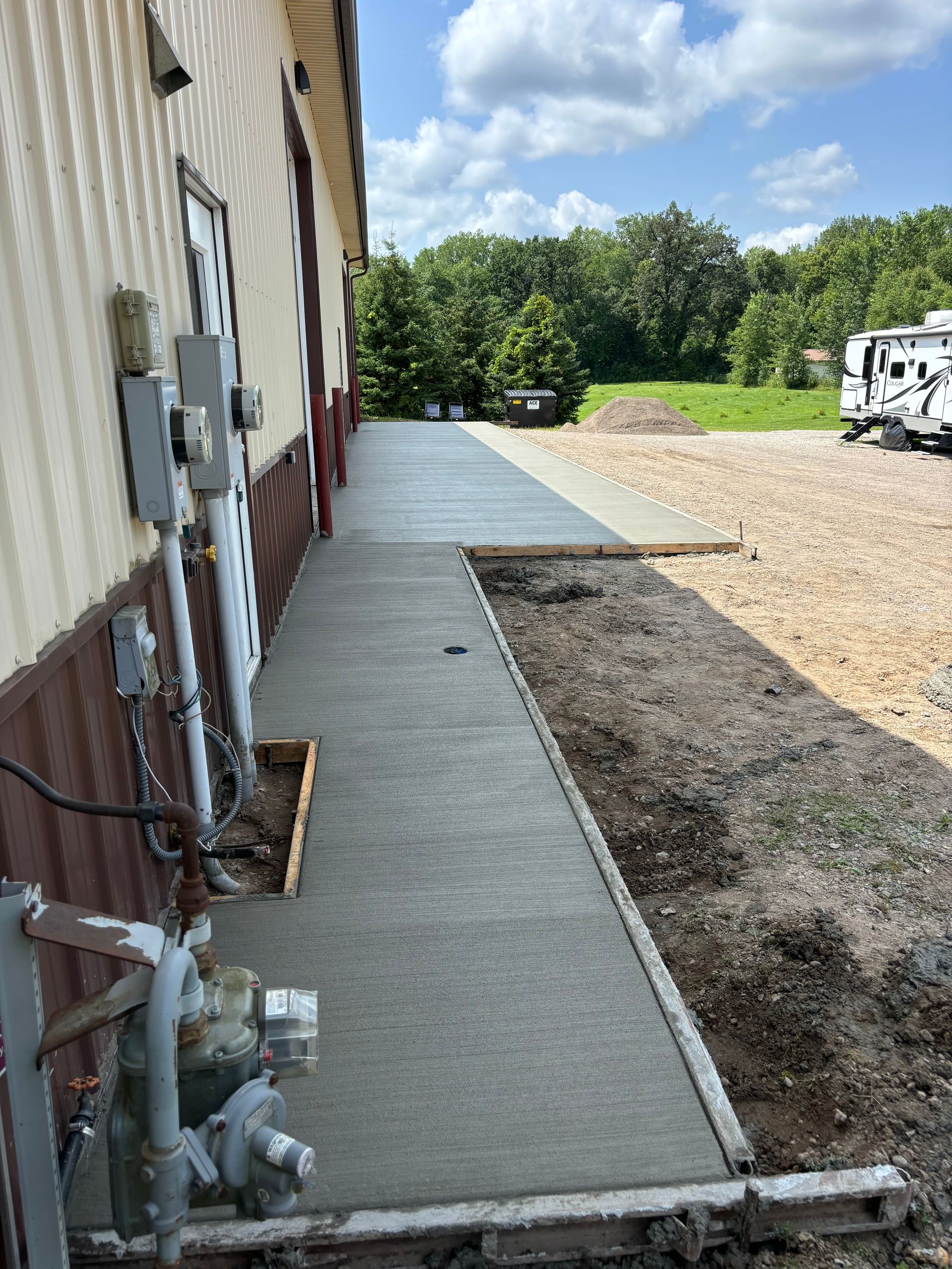 A concrete walkway is being built in front of a building.